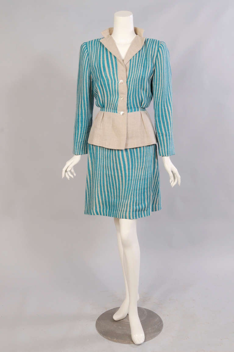 This suit is so clever, the print was applied to the linen to create the design of the garment and eliminate the need extra seams. The front button placket and peplum on the jacket are not separate pieces. The jacket has three pearl buttons and a