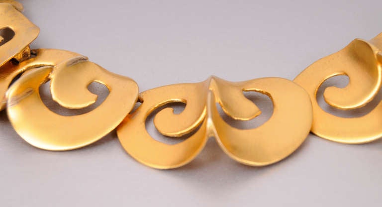 A striking modern design in gold toned metal, this necklace was hand made in New York.