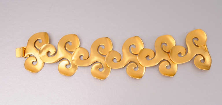 A striking modern design in gold toned metal, this bracelet was hand made in New York.