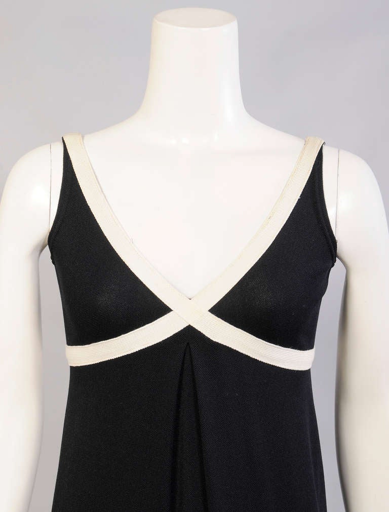 Understated elegance from Rudi Gernreich designing for Harmon Knitwear, the bodice of this black knit dress is trimmed with cream knit bands that define the bust. There is an inverted pleat at the center front and back, with a center back zipper. It