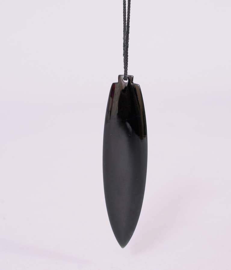 An ancient shape, this arrow in black onyx creates a strikingly beautiful and elegant necklace from the legendary model, muse and designer Tina Chow.  
The onyx is suspended from a long narrow black cord. The necklace is in excellent condition, the