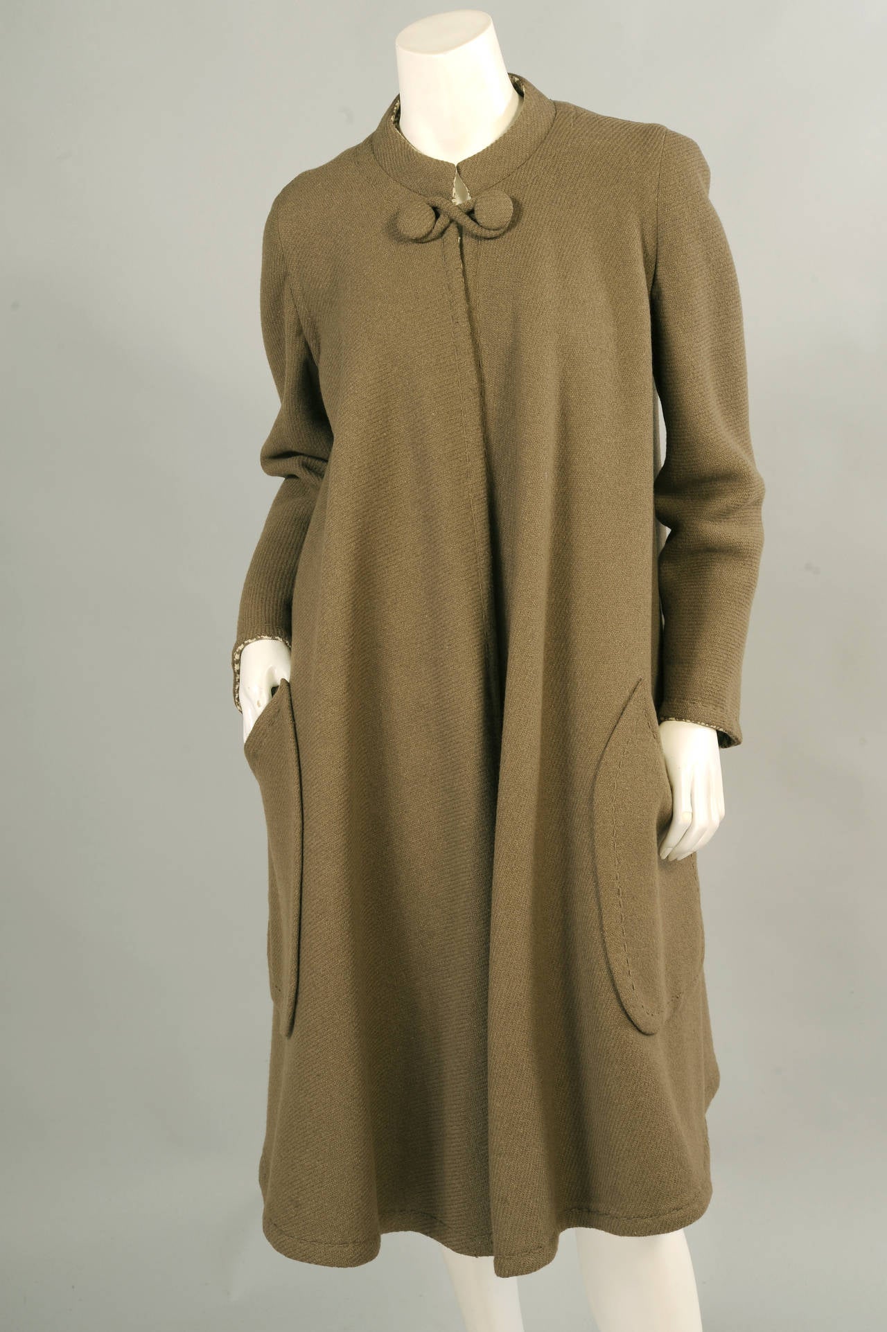 Sybil Connolly, the famous Irish couturiere was well known for using fabrics that were from her native country. The beautiful  green wools in this outfit are excellent examples. The reversible coat is olive green wool with a delicate woven pattern