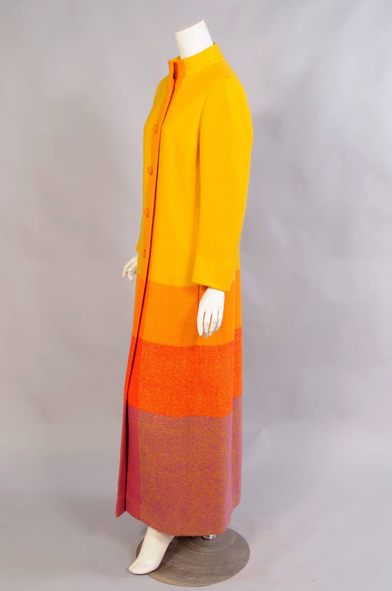 Colorful and charming this Swedish hand woven wool blanket coat will brighten a winter day. It was designed by Countess von Echermann who was the subject of an exhibition at the Hallwyl Museum in Stockholm in 2011. The coat has five covered buttons