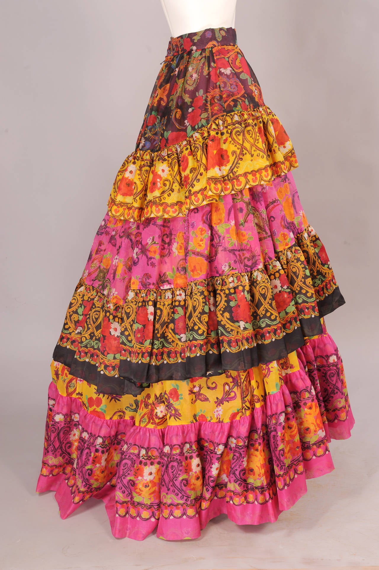 Christian Lacroix has combined five colorful printed fabrics into this beautiful tiered evening skirt. Just add a simple T shirt or cashmere sweater. The skirt has a natural waistline and it is slim over the hips, and then it becomes a fiesta! There