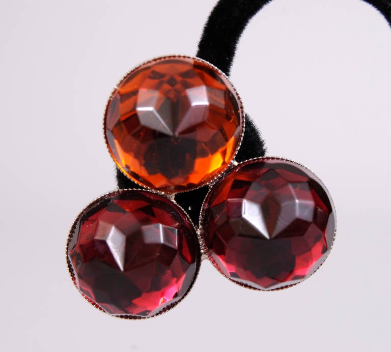 These three stone clip on earrings from YSL change color as they catch the light. One large faceted stone is a deep amber and the other two are a deep dark red. They have never been worn and still have the original YSl hang tag. They are in