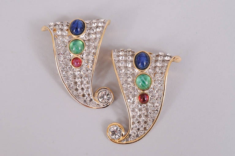 These Valentino earrings have  rhinestones set into a lattice work background. Faux cabochon sapphire, emerald and ruby stones add color and a large faceted rhinestone at the bottom adds sparkle. They are in pristine condition.