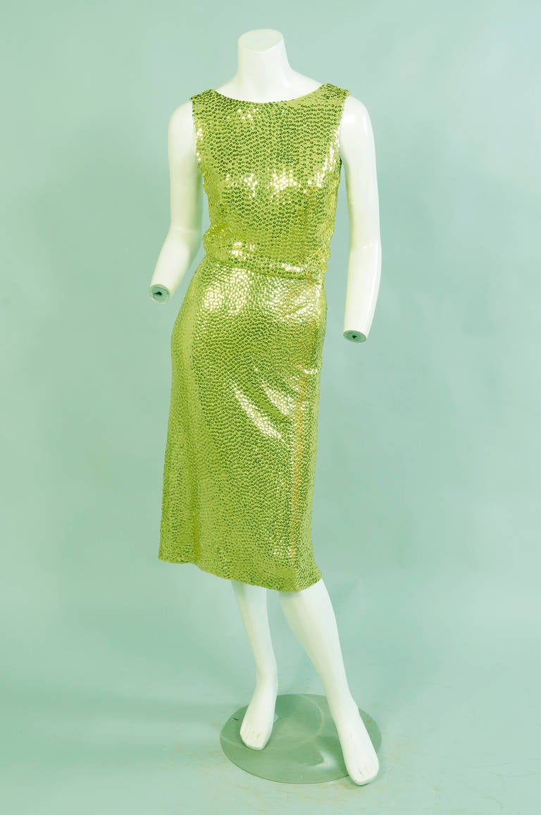 Chartreuse silk jersey is covered with matching chartreuse sequins, all hand sewn, for this early Mermaid dress from Norman Norell designing at Traina-Norell.
The sleeveless dress has a scoop neckline in front and a low cut back. The bodice has a