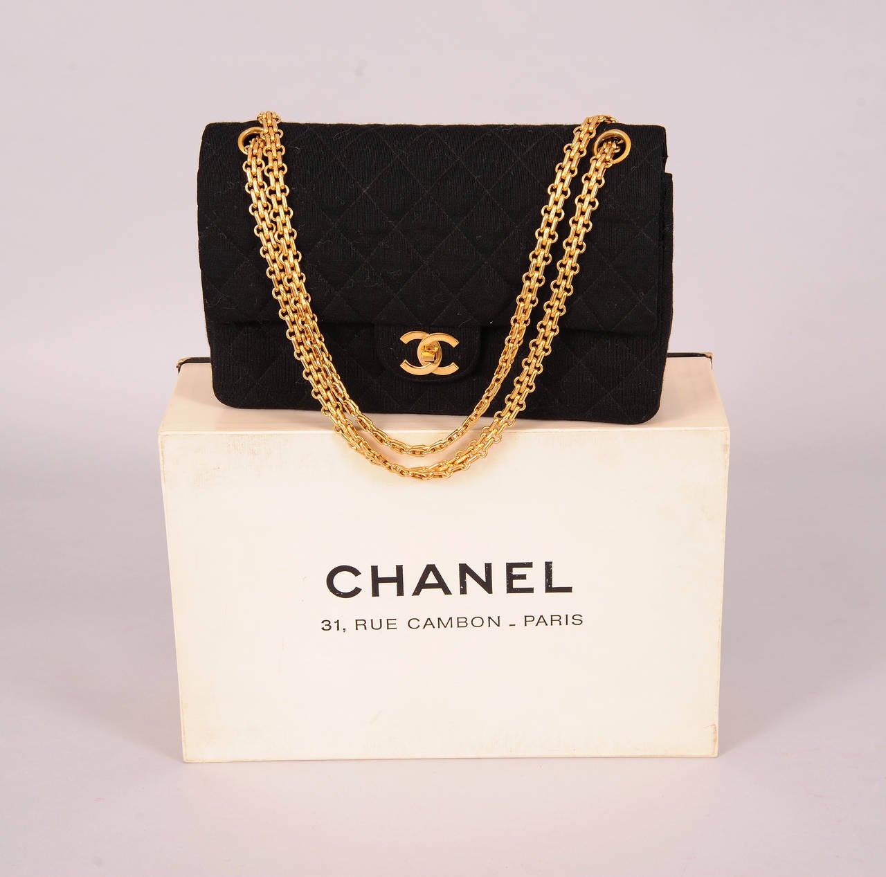 A classic double flap bag from Chanel has a zipper pocket inside the first flap and two open compartments lined In red faille.  The larger section has two slip pockets and an open pocket fro lipstick. The back of the bag also has a slip pocket. A