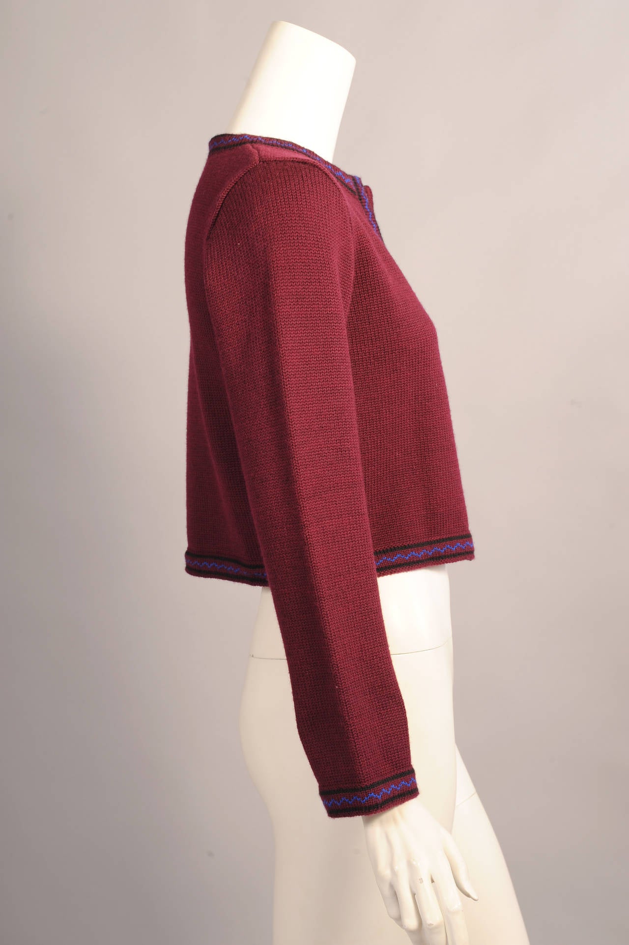 A great burgundy cardigan sweater is accented with an applied knit band of burgundy with two black bands and a center zig-zag of electric blue. The sweater is marked a vintage size Medium and it is in excellent condition.
Measurements;
Shoulders