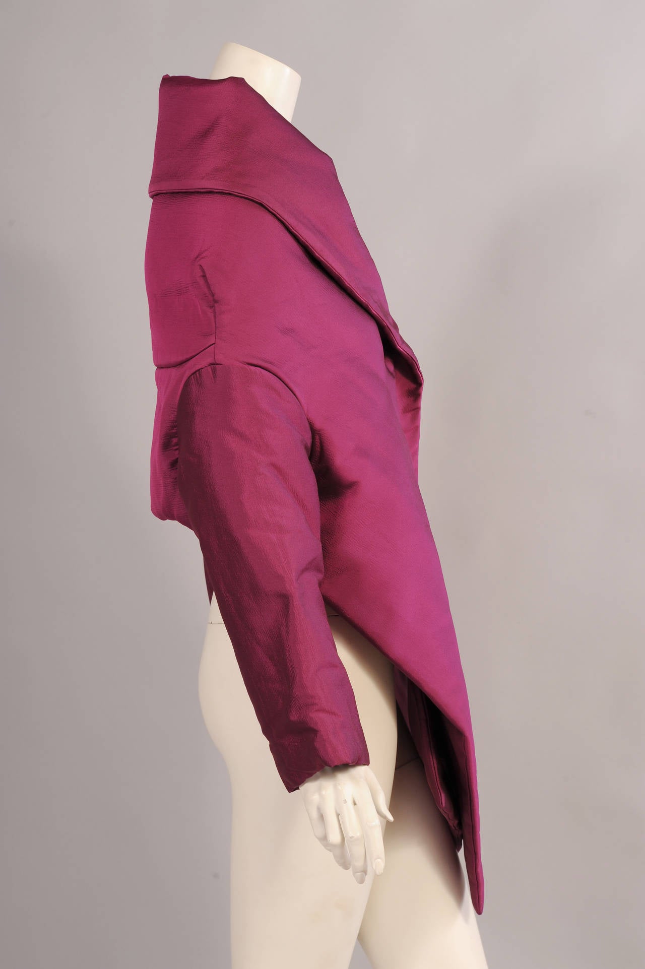 A deep shawl collar wraps across the front of this short jacket from Romeo Gigli. The back just grazes the waistline with a generous amount of collar adding drama. The fabric is a silk blend and it is in excellent condition. It is marked a size