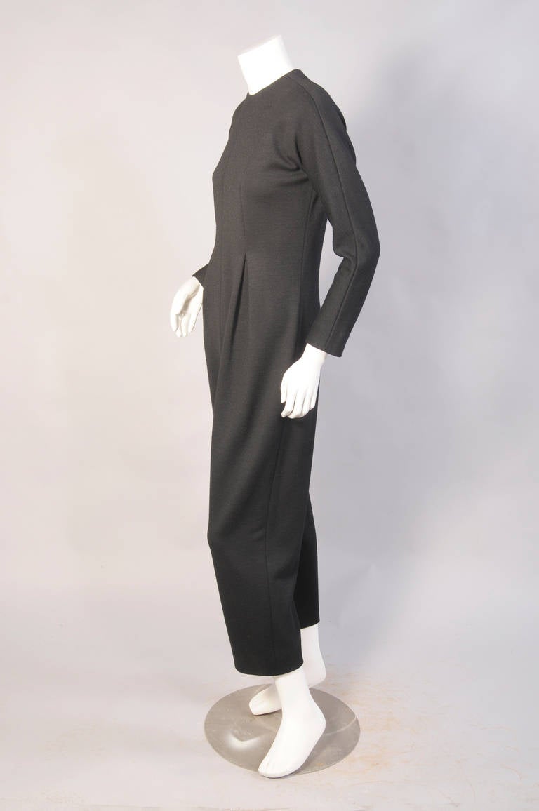 This black wool knit jumpsuit is spare and elegant. It has a center back zipper and it is in excellent condition. It is perfect with the loden green bolero and the coat as pictured.
Measurements;
Bust 38