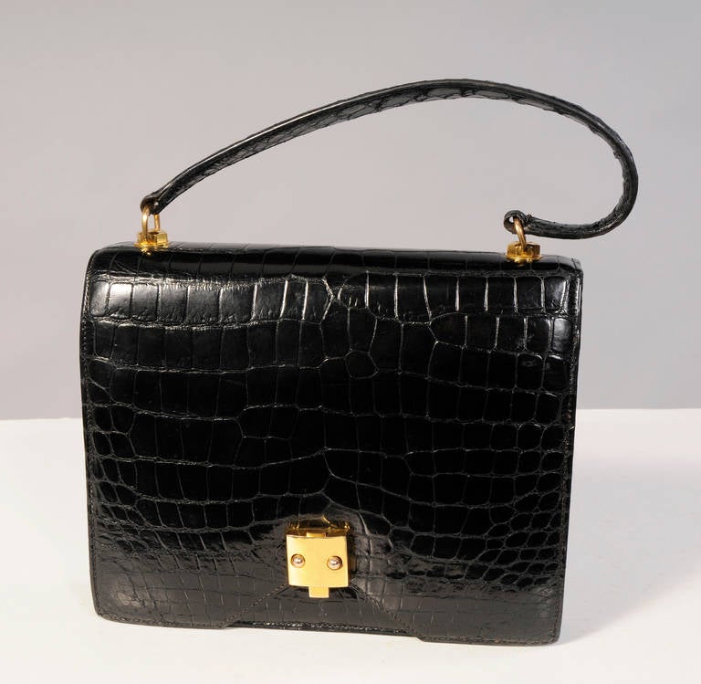 Hermes uses only the finest exotic skins for their coveted classic and timeless handbags. This vintage bag is made from soft and supple black crocodile and it is fully lined in ultra soft black lambskin. The bag has gold hardware with a chic and