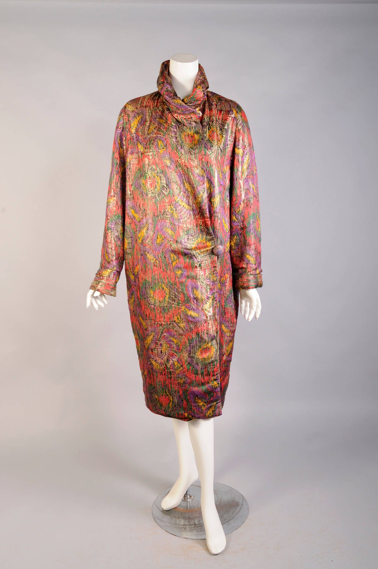 Gold lame is combined with bright and cheerful shades of red, yellow, green and purple with accents of black for this stunning 1920's evening coat. It is fully lined in green silk velvet and it is in excellent condition.
Measurements;
Shoulders 15