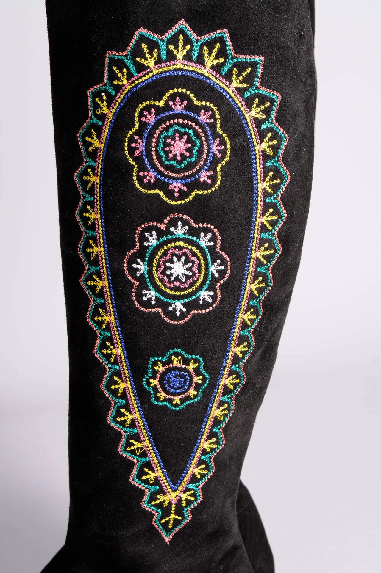 Tall black suede boots are embellished with colorful embroidered botehs. The boots have a side zipper, they are lined in black leather and they have leather soles. They have never been worn and they are marked a size 41. Please email if you need any