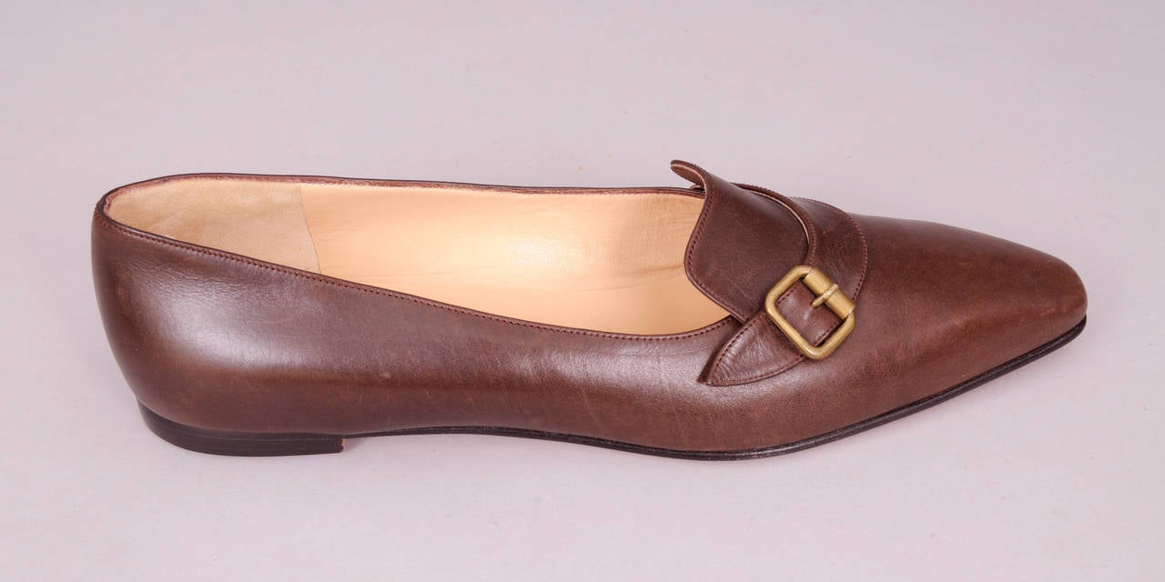 Classic and elegant these dusky brown all leather flats have a brass buckle on one side. Marked a size 39 1/2 they have never been worn and they are in excellent condition.