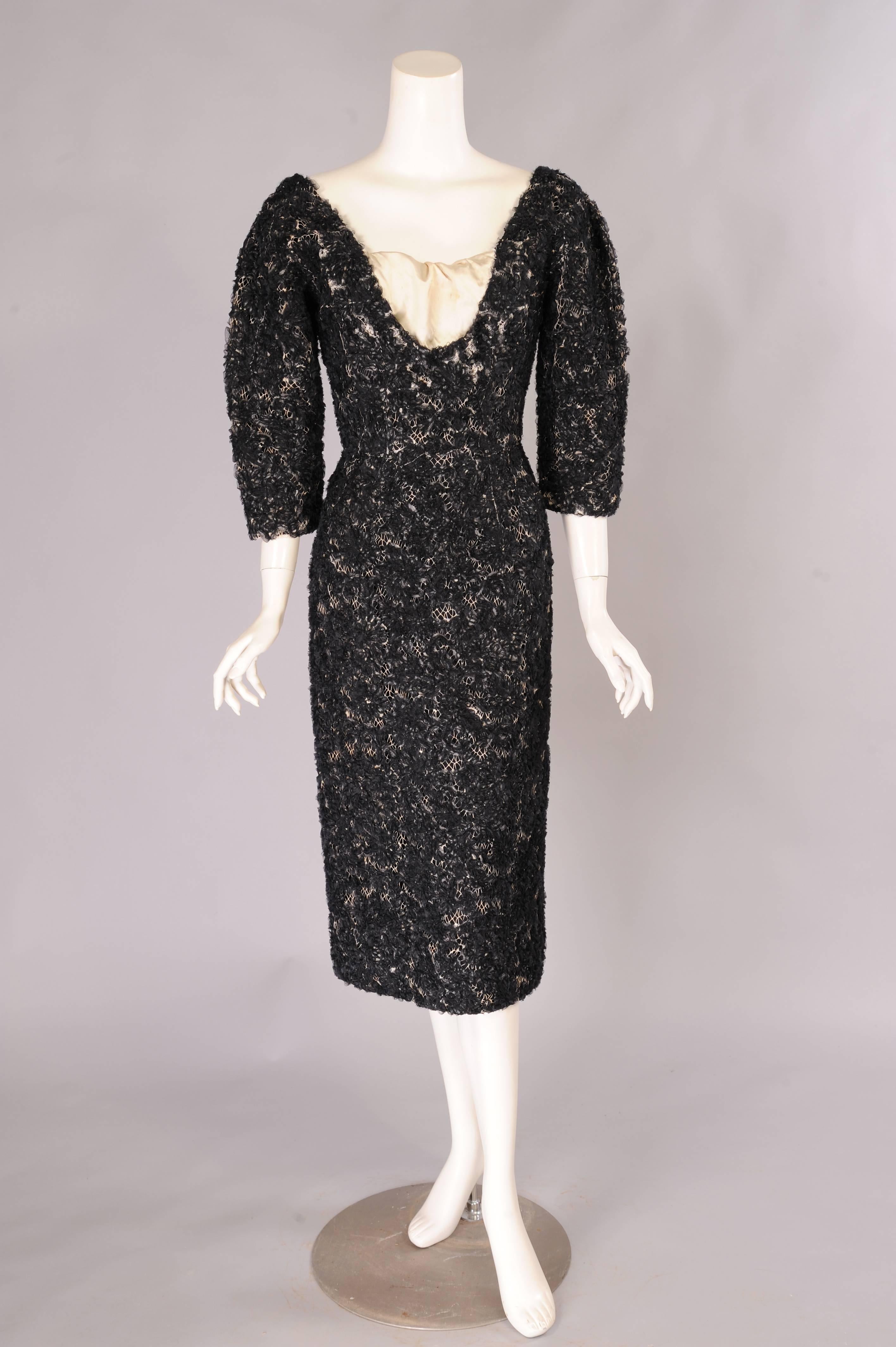 A 1950's Diorcouture dress from the estate of an American lady who fell in love with and married an Italian Count. The workmanship in this dress is just amazing. A cream colored lace dress is re-embroidered with sheer black silk ribbon creating a