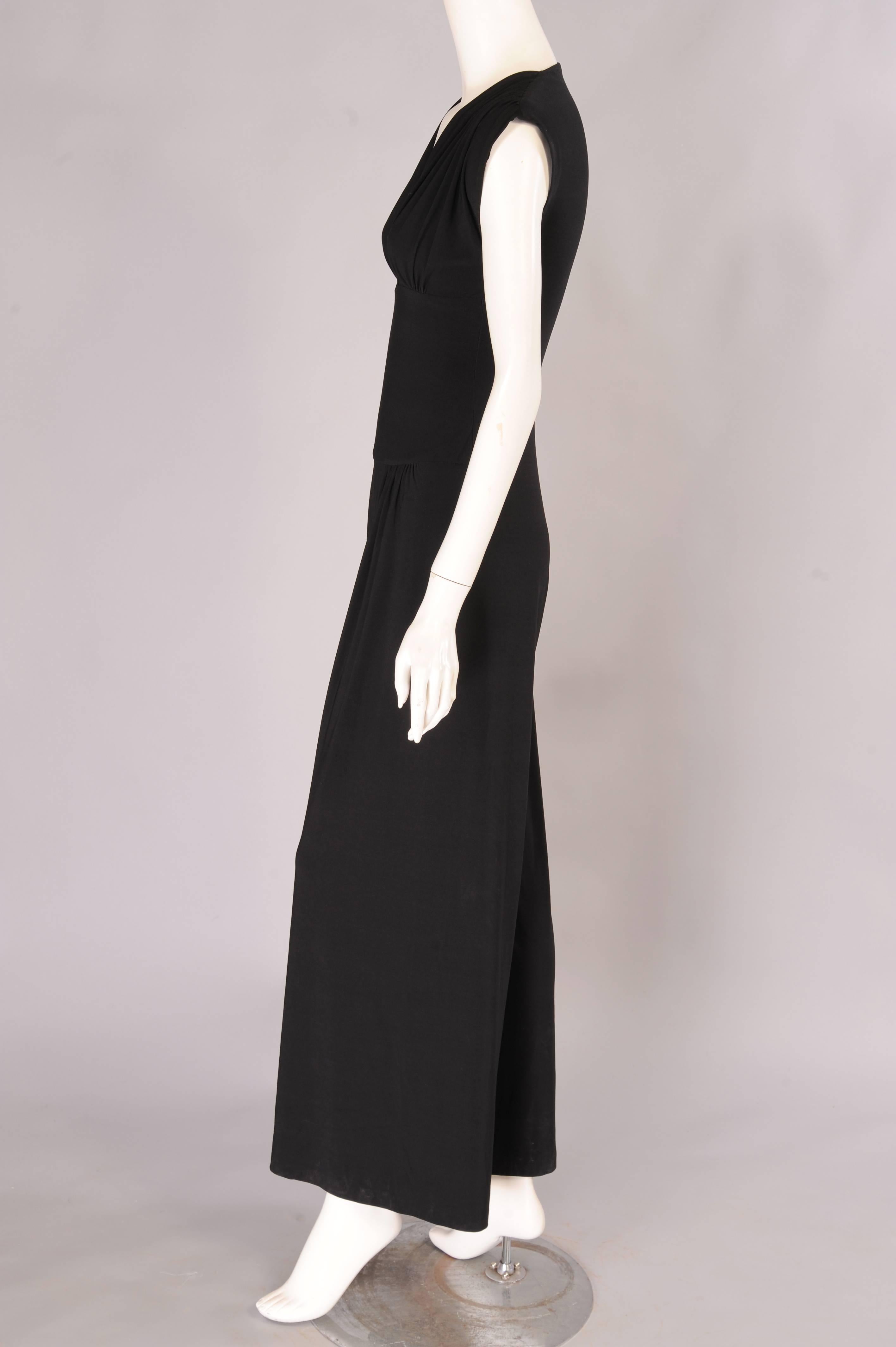 A sexy shape and a stretchy fabric make this a great jumpsuit for day or evening. The gathered top has a V neckline above a flat mid section. The pants are cut full and it just pulls on, no zippers or hooks. It is in excellent condition and marked a