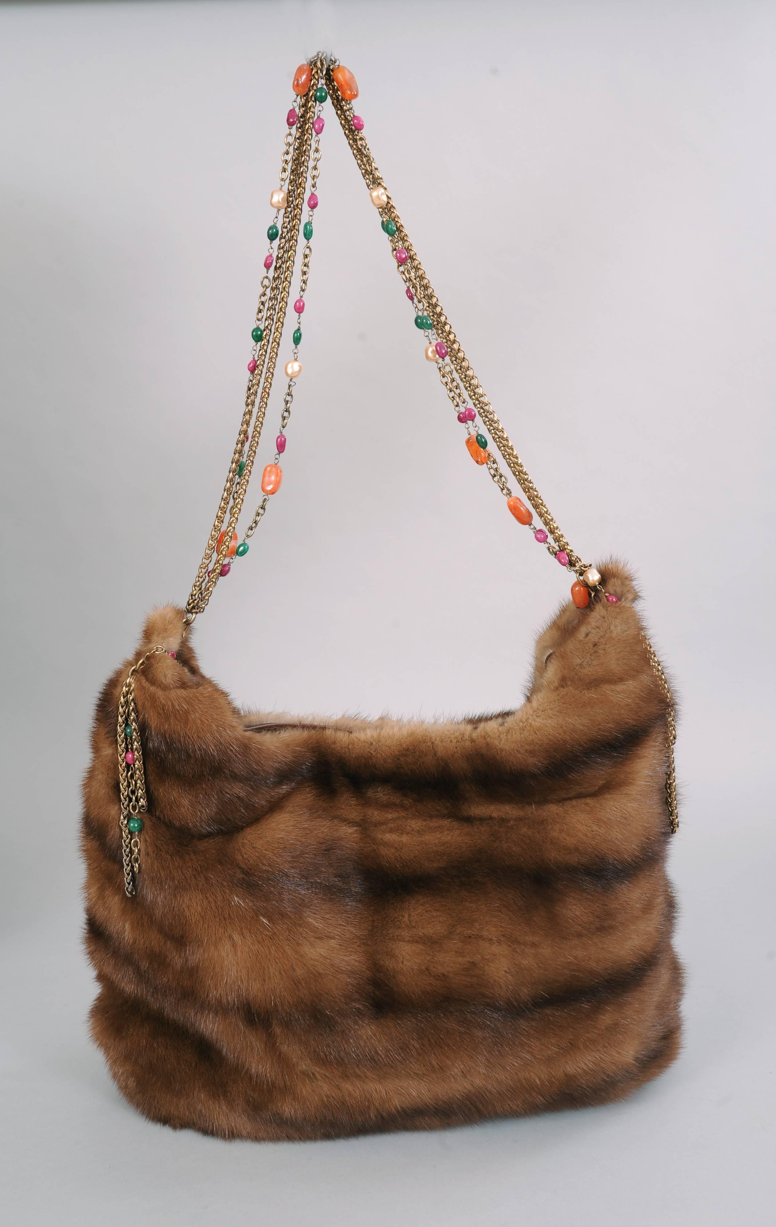 Beautiful, soft and supple ranch mink is used for this large shoulder bag designed by Oscar de la Renta. Produced in a limited number the bag has a beautiful multi chain shoulder strap set with cabochon stones and pearls. It has a snap closure, a