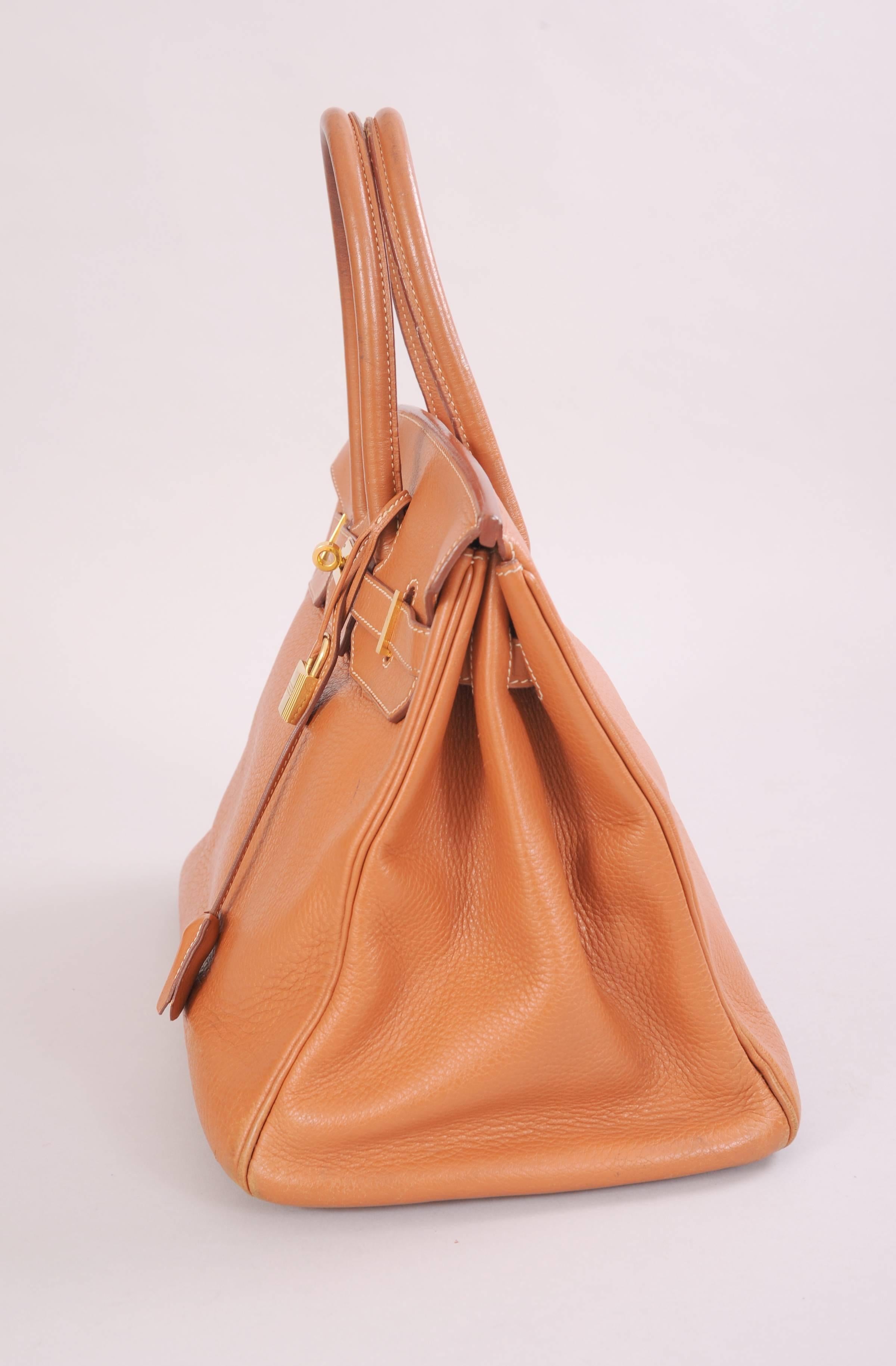 This 35 cm Birkin bag dates to 2000. It is part of a collection of handbags that I recently acquired from a fashion industry executive. The bag retains the original lock, keys, clochette and the sleeper bag. This bag is priced to reflect condition.