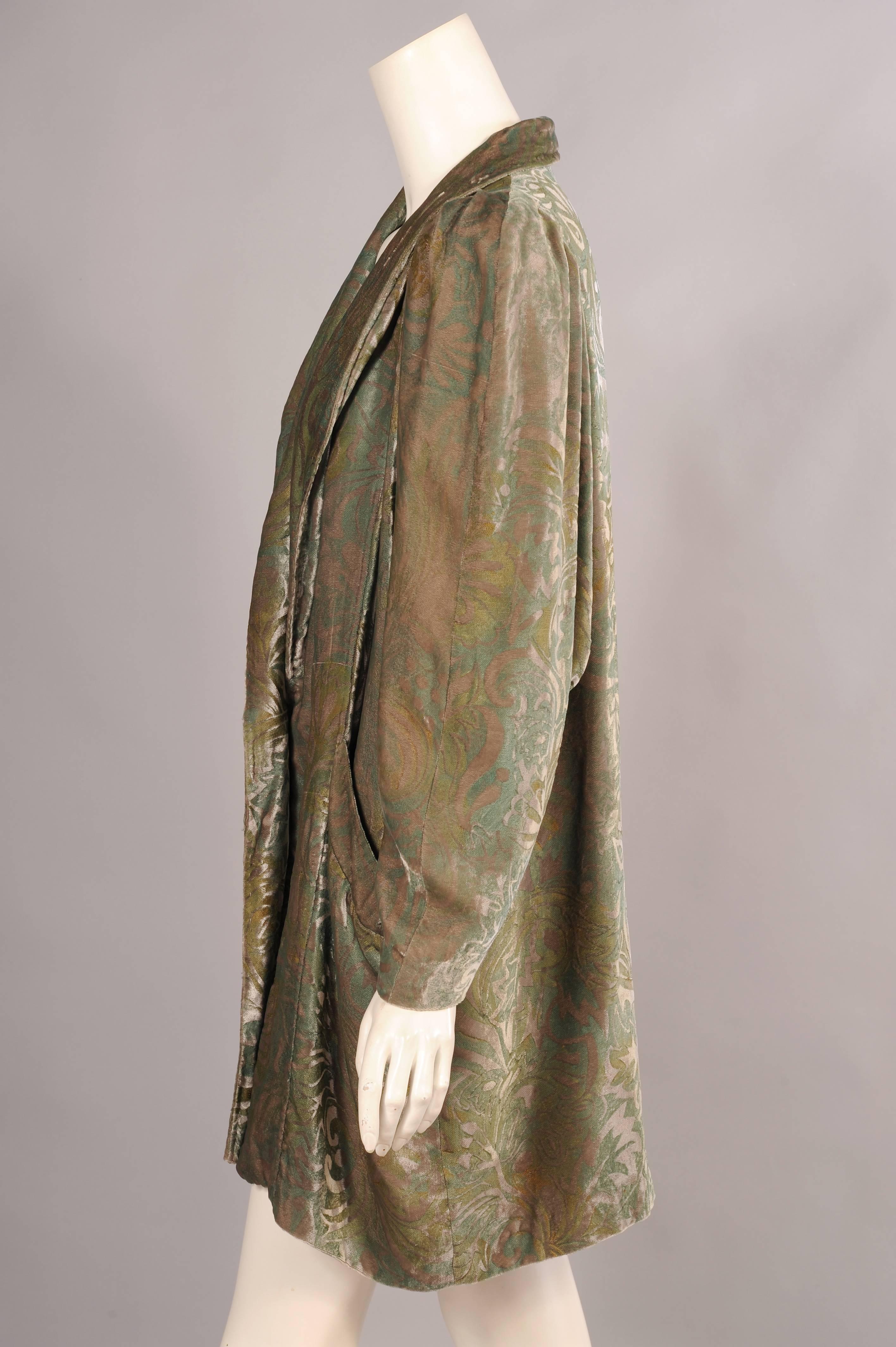 Silver grey, pale green and gold all combine in this stenciled design on the velvet evening jacket or coat. Created in the 1920's in the style of Fortuny or Gallenga unfortunately this coat is not labeled or signed. It has a shawl collar, full