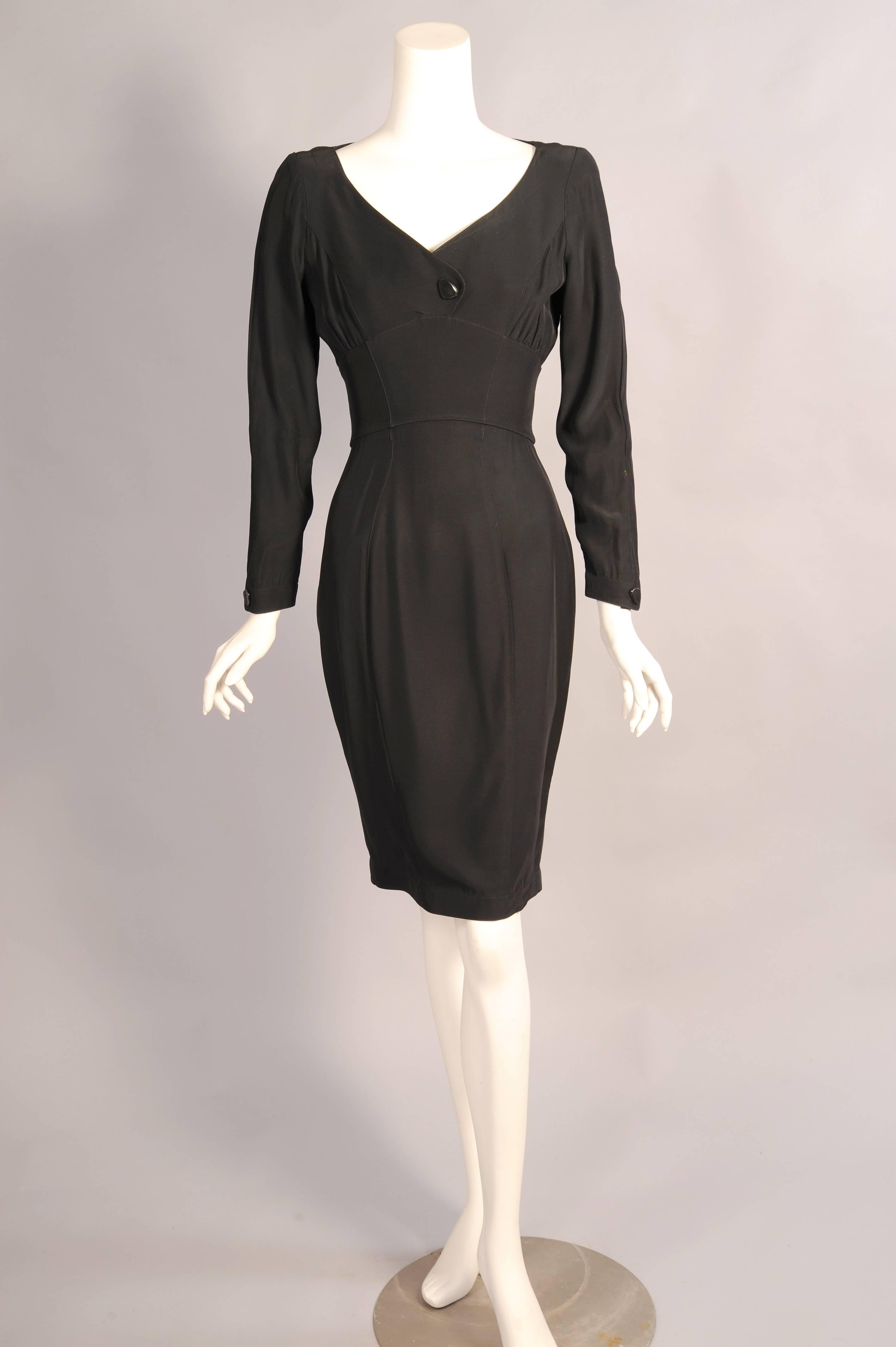 A satin backed crepe is used for this scoop neck, Empire waist dress. Decorative contemporary buttons conceal snaps at the bust, wrist, and all the way down the back. The dress is in excellent condition.
Measurements;
Shoulders 15.5