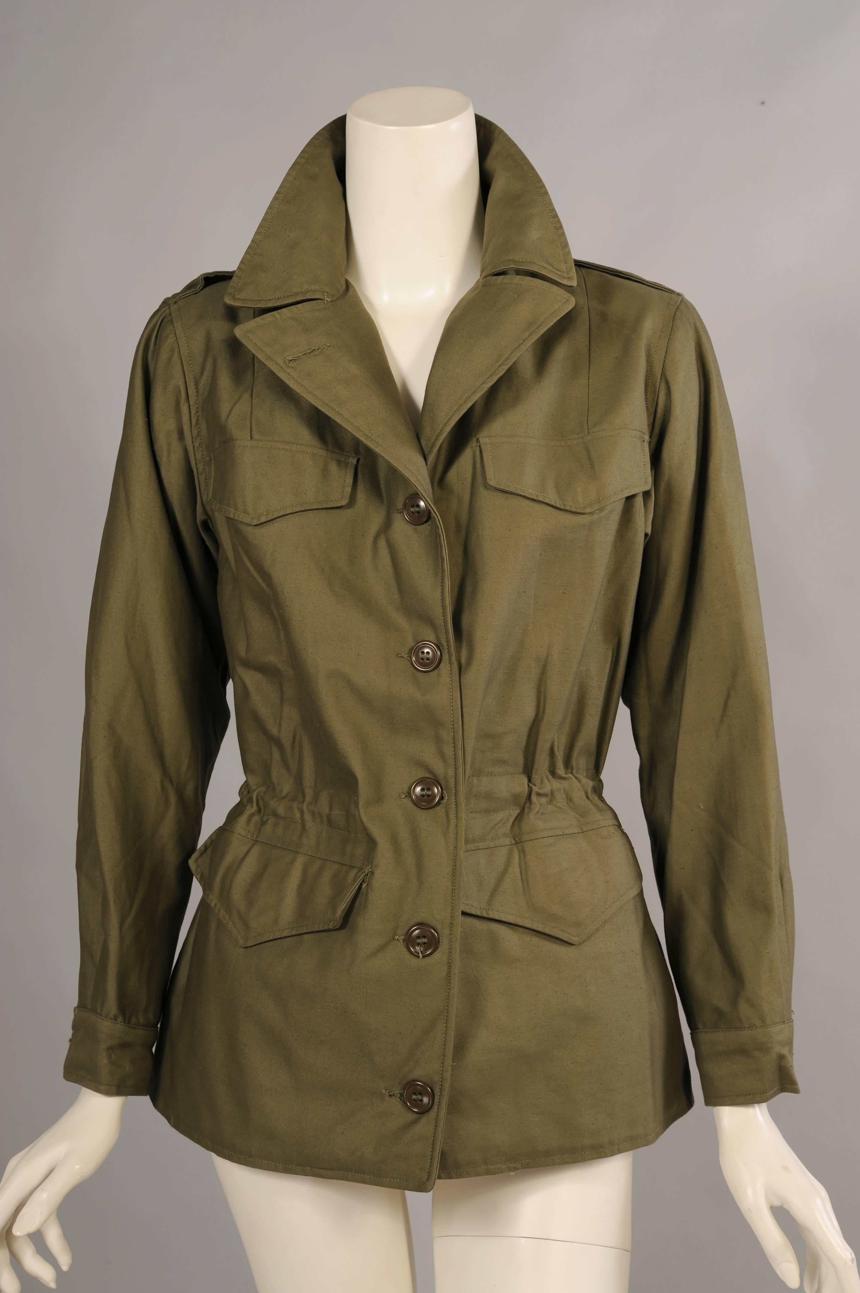 From the estate of a WWII Red Cross nurse, this olive drab jacket is beautifully designed and looks very contemporary. There are two faux breast pockets, two hip pockets with hidden button tabs and an interior drawstring to adjust the fit of the