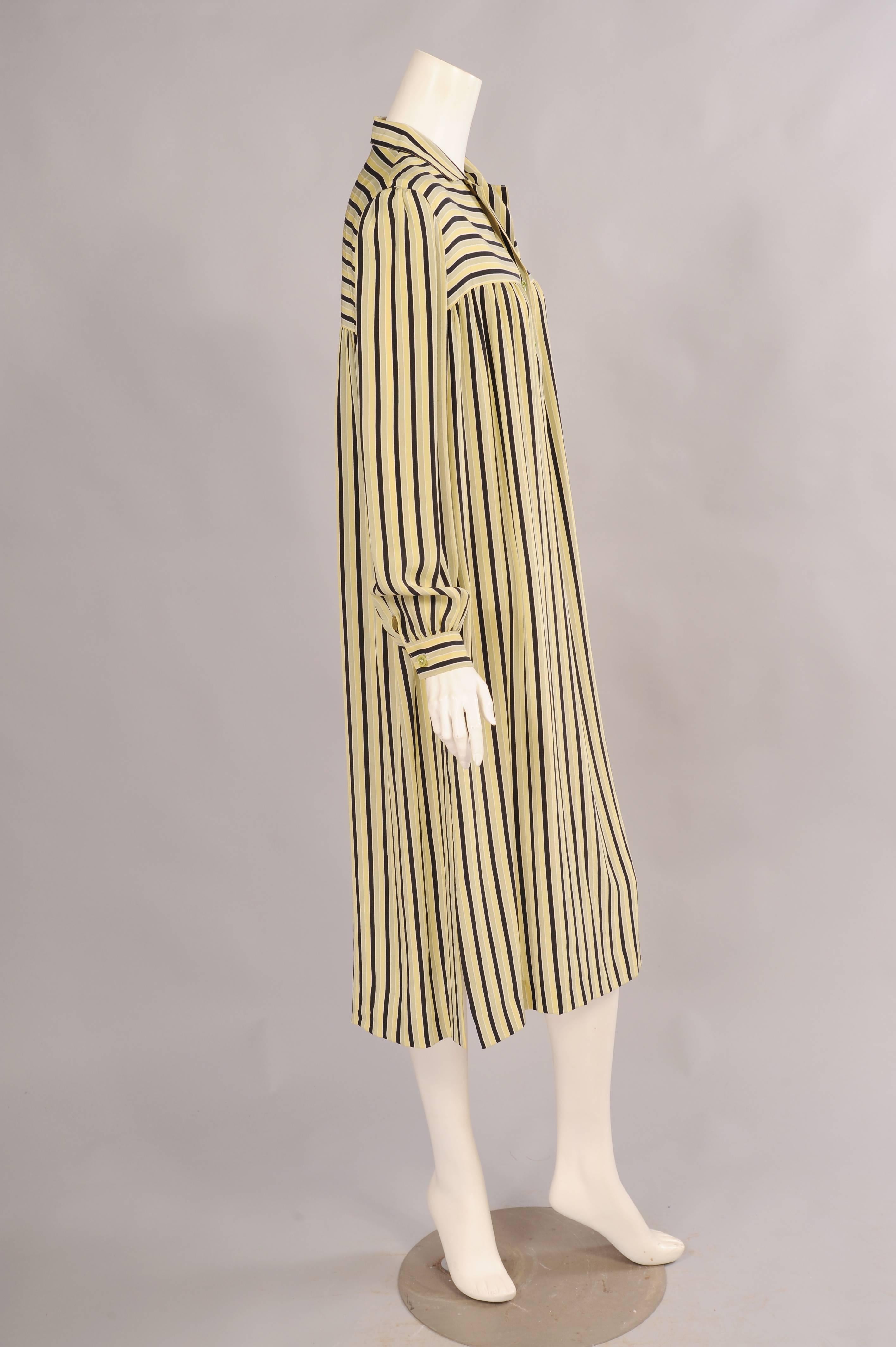 This 1970's Guy Laroche striped silk dress has a horizontally striped  yoke at the front and back above the vertically striped body of the dress. It slips on over your head and there are buttons at the center front. The long sleeves have button
