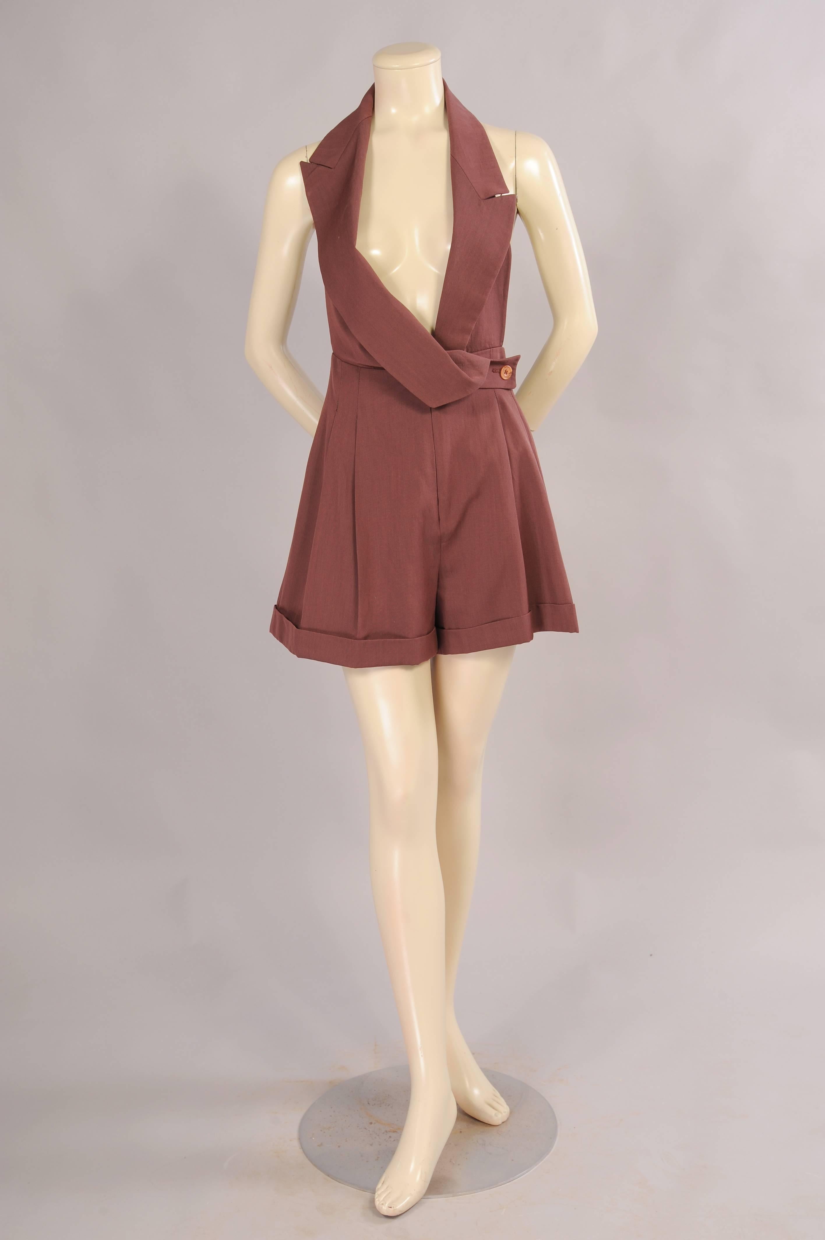 A cocoa brown wool and cotton blend is used for this "formal" shorts outfit with off center notched lapels. The lapel notch sits high on the right shoulder and drapes across to button on the left side. There is an invisible zipper at the