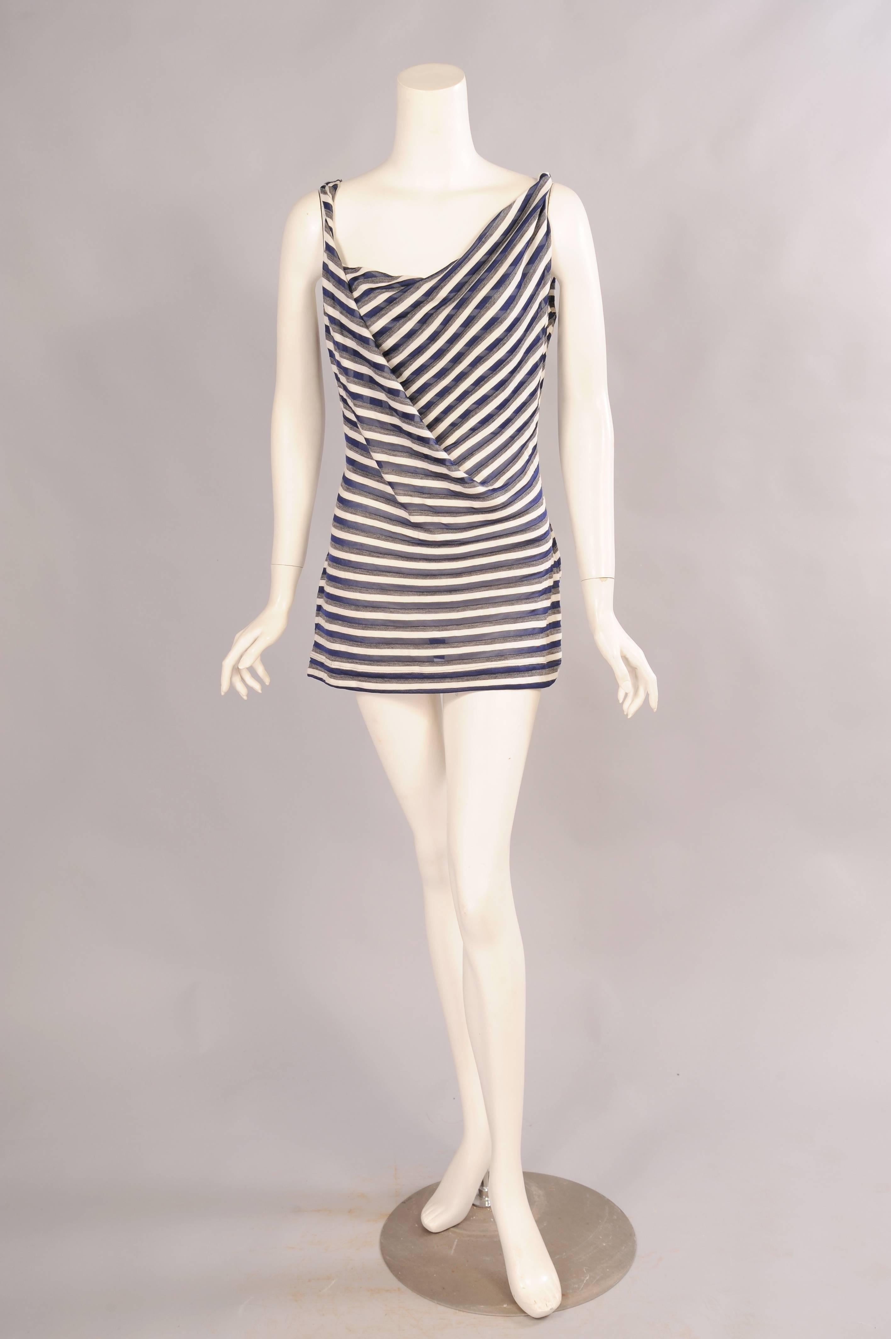 A basic tank is elevated by a draped front, twisted straps and super soft and semi sheer fabric. It is an equal blend of wool, cotton and acetate. The top has never been, retaining the original hang tag. It is in excellent condition and marked a
