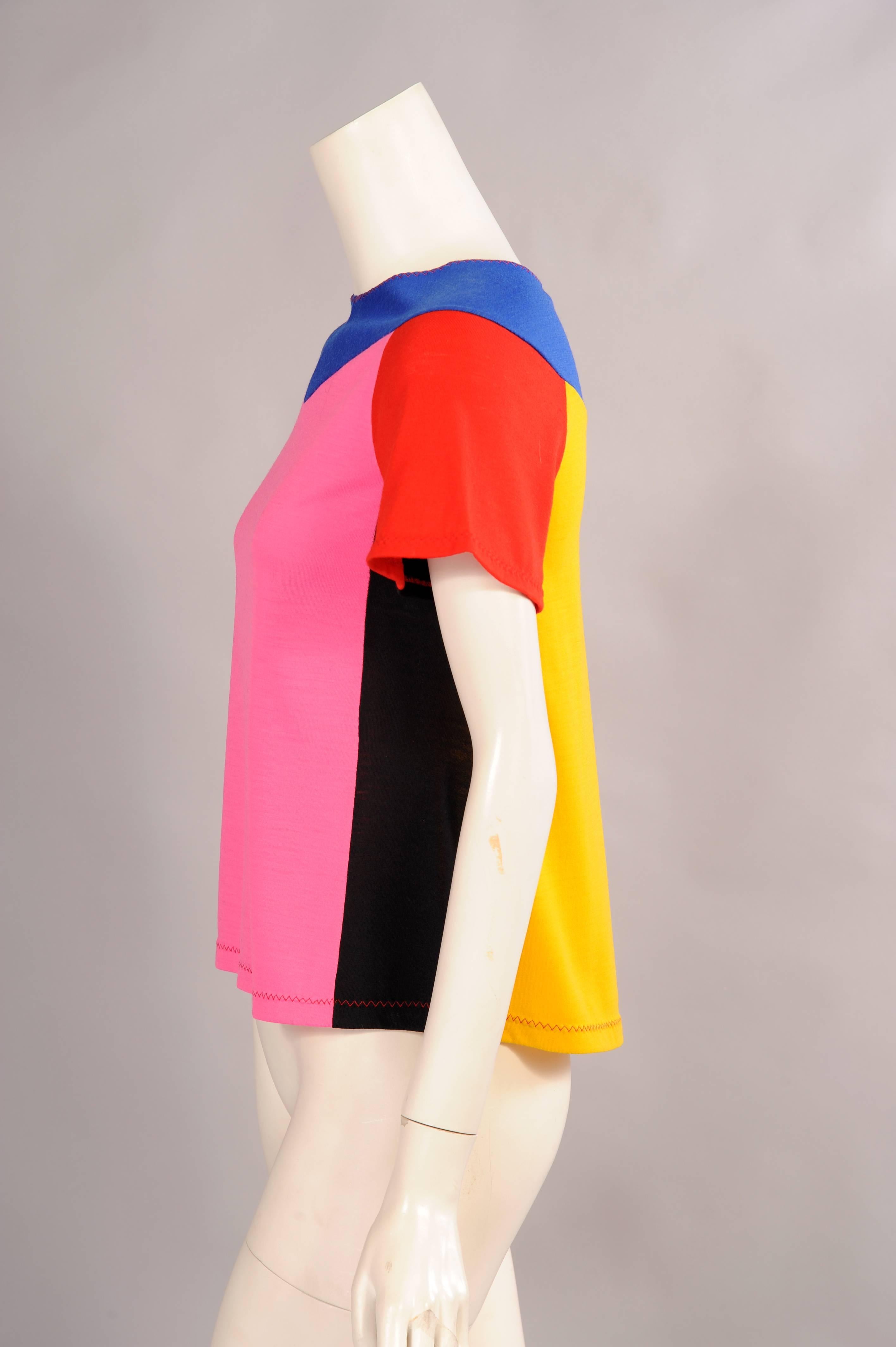 Retailed by Giorgio of Beverly Hills this fun top from Stephen Burrows is made from five different colored fabrics. The top is edged with red stitching at the neckline, sleeves and hem. It is in excellent condition.
Measurements;
Shoulders