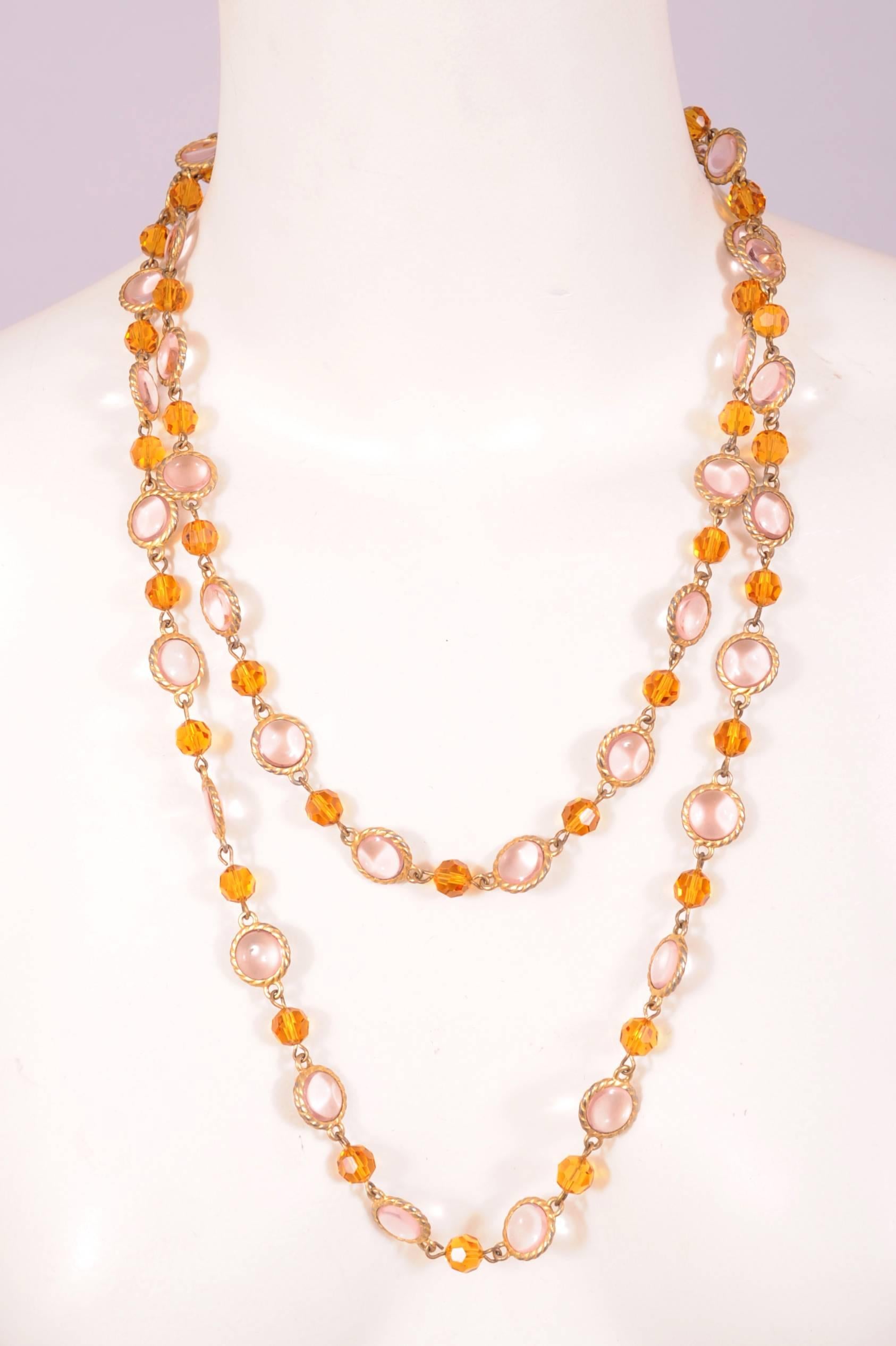 This necklace has pale pink cabochon stones and faceted gold stones on a gold toned metal link chain. It has a clasp so it can be worn doubled or tripled for different looks. The necklace is in excellent condition.
Measurements;
Length 50