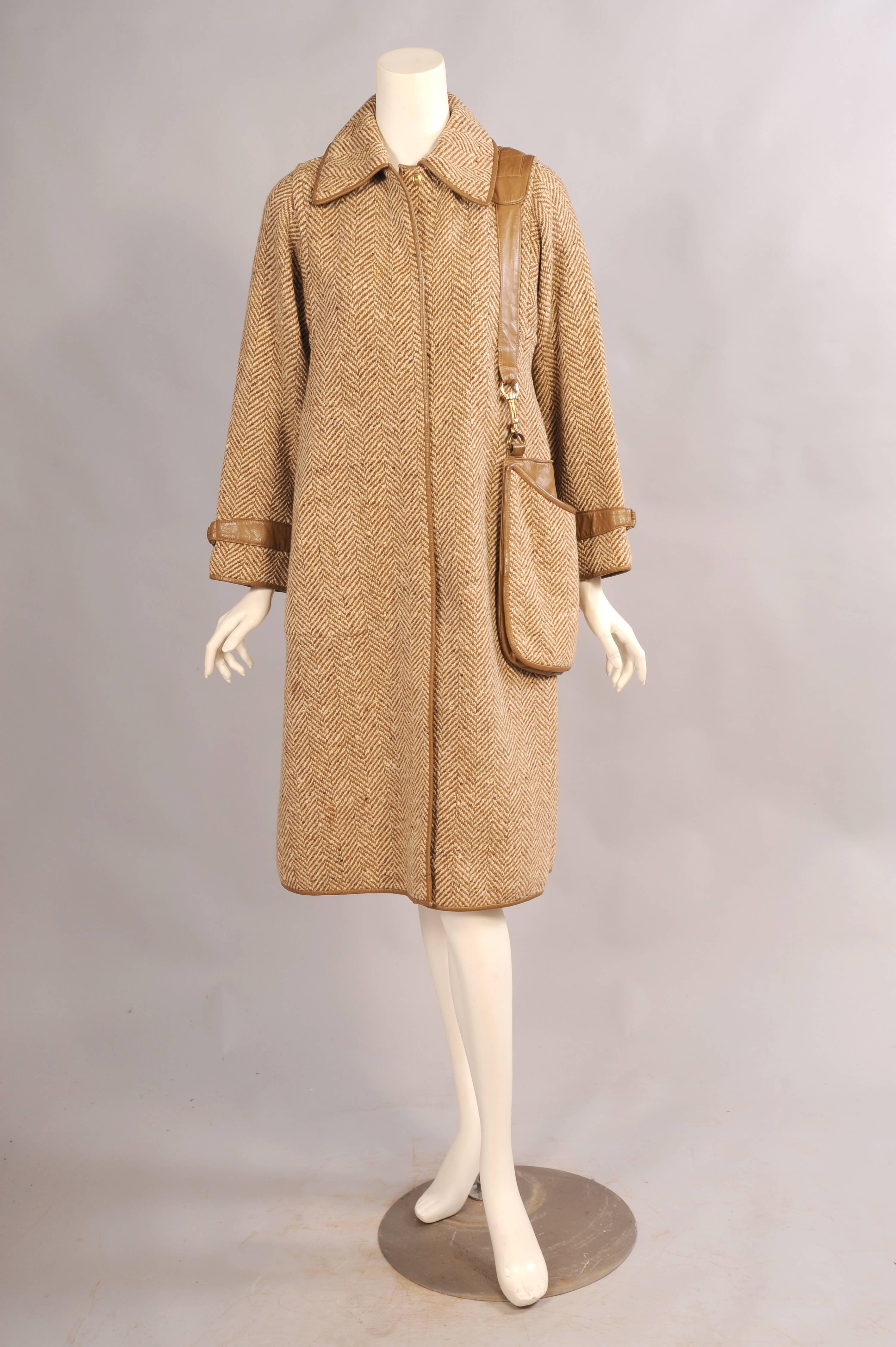This is such a fabulous and practical design. A gorgeous brown and cream  herringbone patterned wool is trimmed with copious amounts of brown leather. The front, the hem and cuffs are all banded in leather. The collar is lined with leather and the