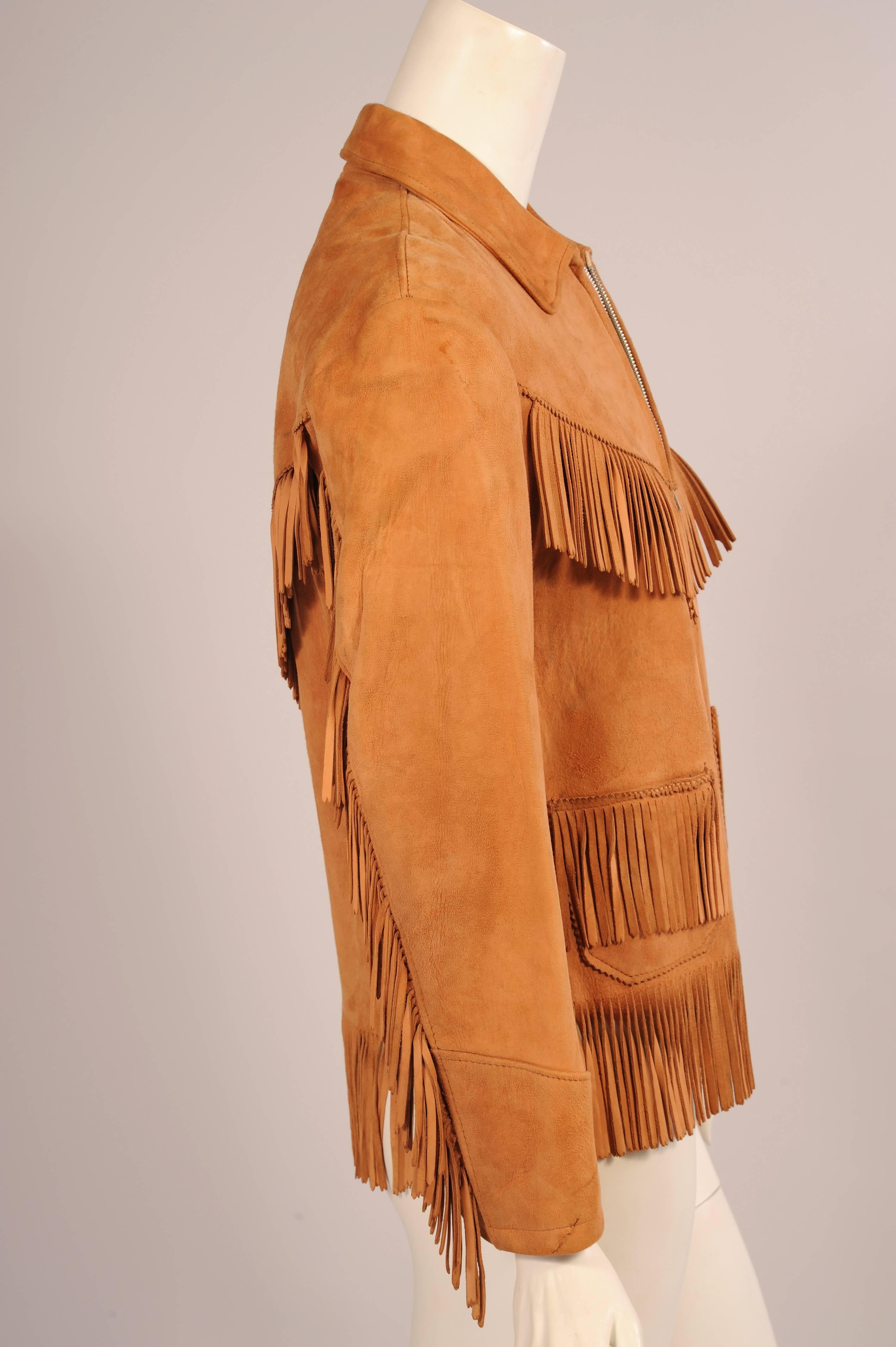 This Western style suede jacket has fringe trim on the front and back yokes, the sleeves, the pockets and the hemline. It has a metal zipper at the center front and it is fully lined . It is in excellent condition.
Measurements;
Shoulders
