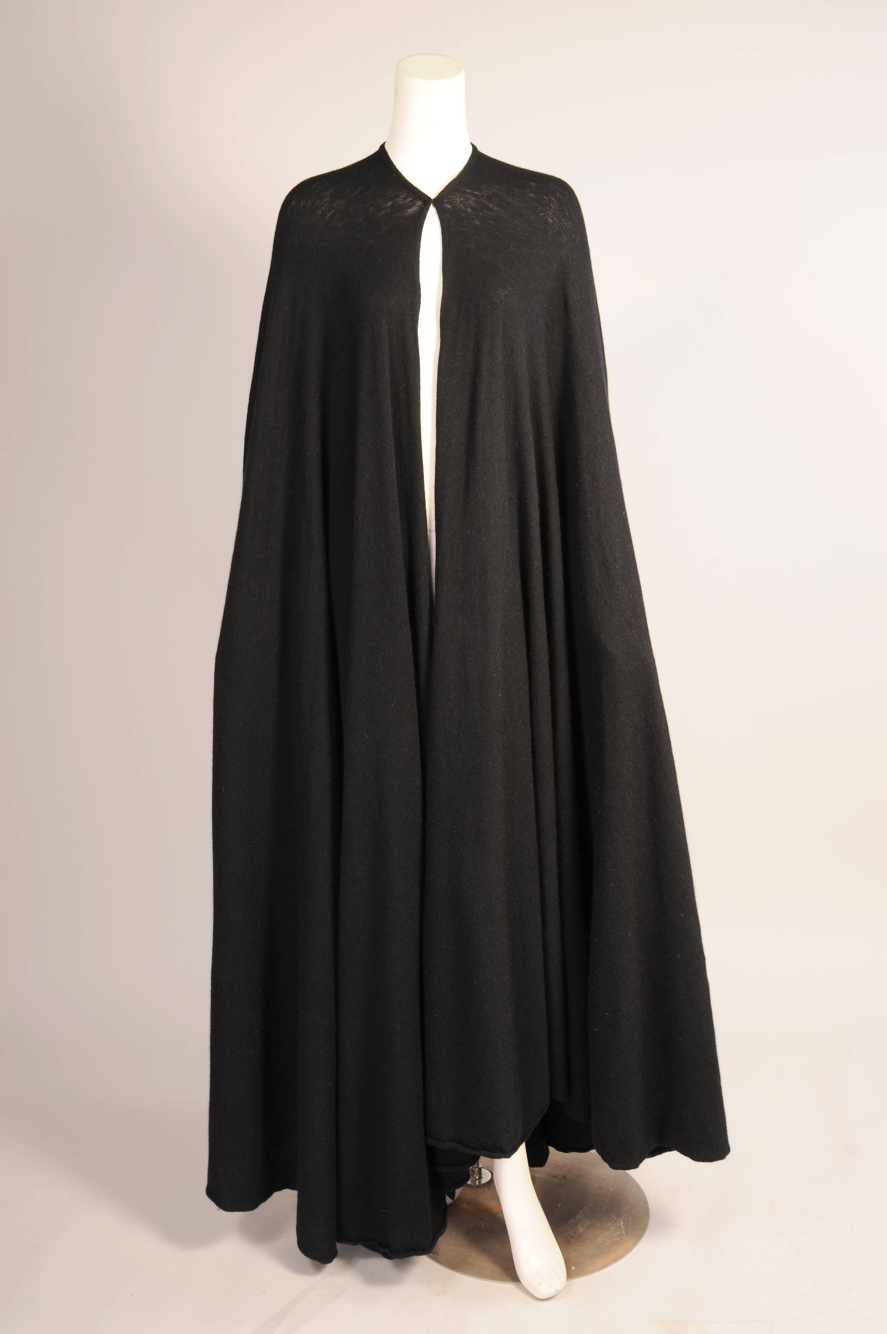 Madame Gres is famous for her draping and this fluid black wool jersey cape is a spectacular example of her work. The cape is made from a luxuriously soft fabric and it has a single hook and fabric eye closure and only three seams. It drapes and