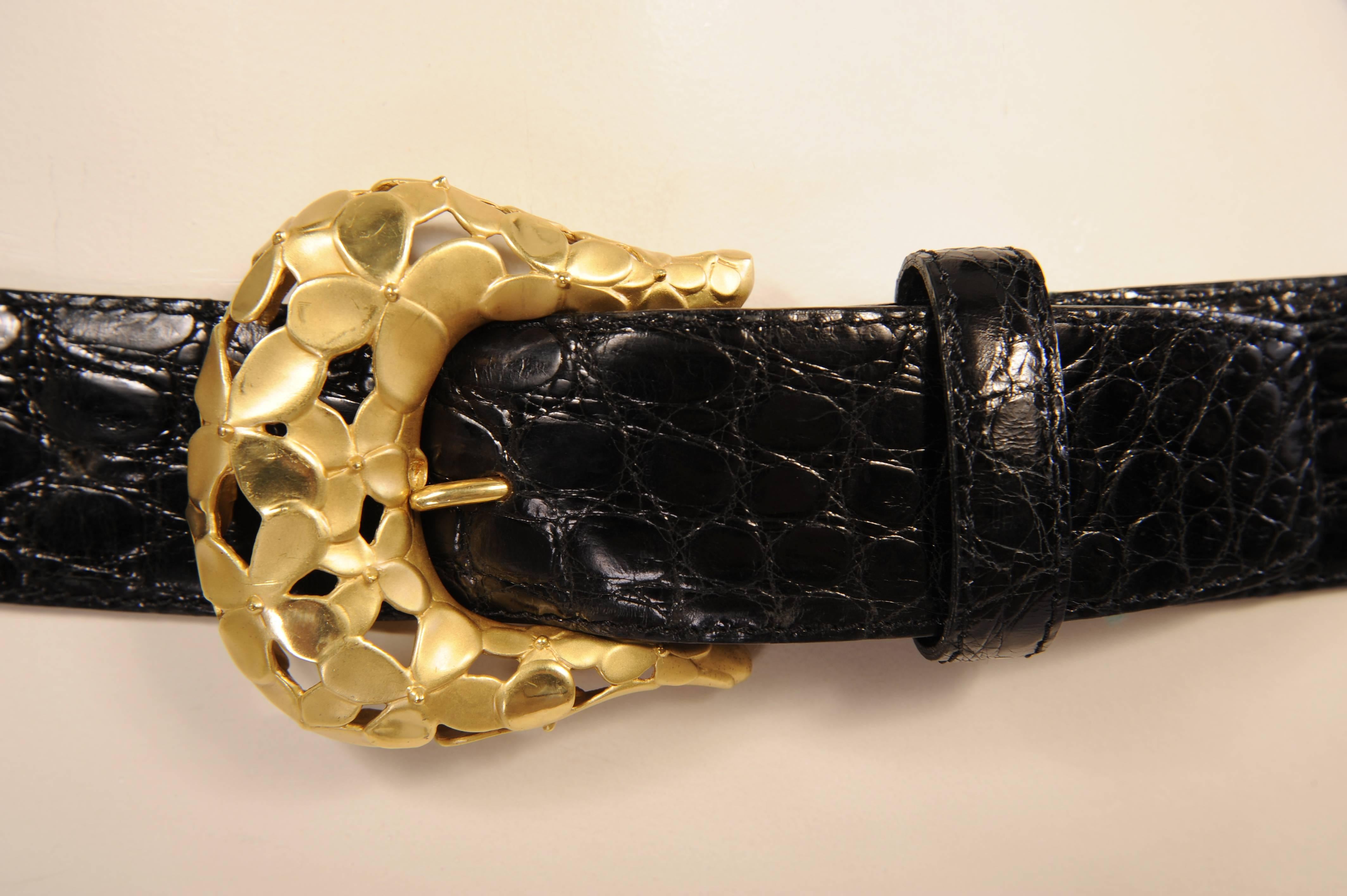 A beautiful gold floral buckle of matte and shiny petals pairs beautifully with the glistening black alligator belt. The buckle is sterling silver with gold vermeil. It is fully marked on the back and the belt is stamped. Designed by Angela