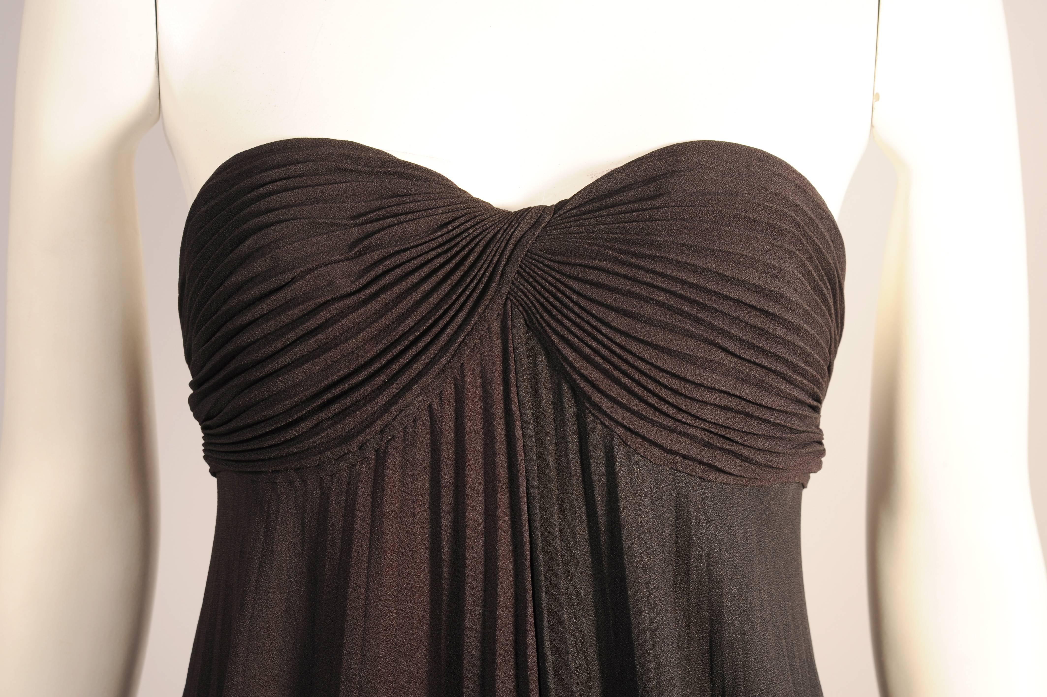 This elegant dress is a very subtle combination of the deepest bittersweet chocolate brown and inky black crepe. The dress is divided right down the middle. The bodice is black on the right side above the brown half of the dress and it is brown over