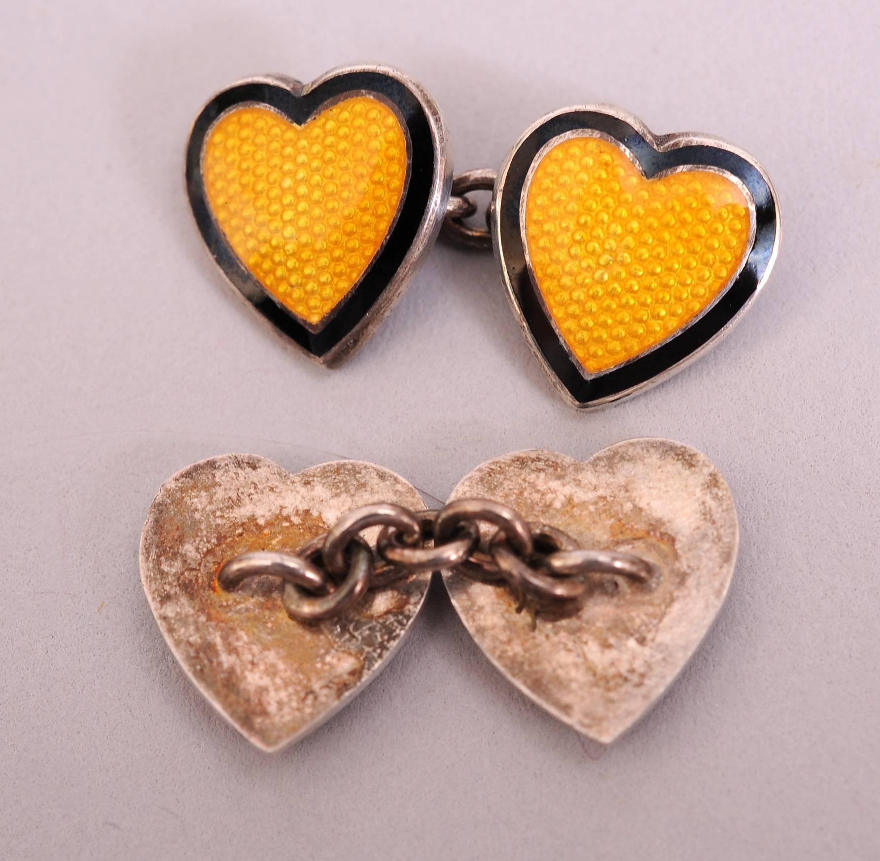 A charming yellow enamel heart is surrounded by a band of navy blue with two bands of silver. It is connected by a short chain to a matching heart for the back of the cufflink. This lovely pair is in excellent condition.
Measurements;
Height