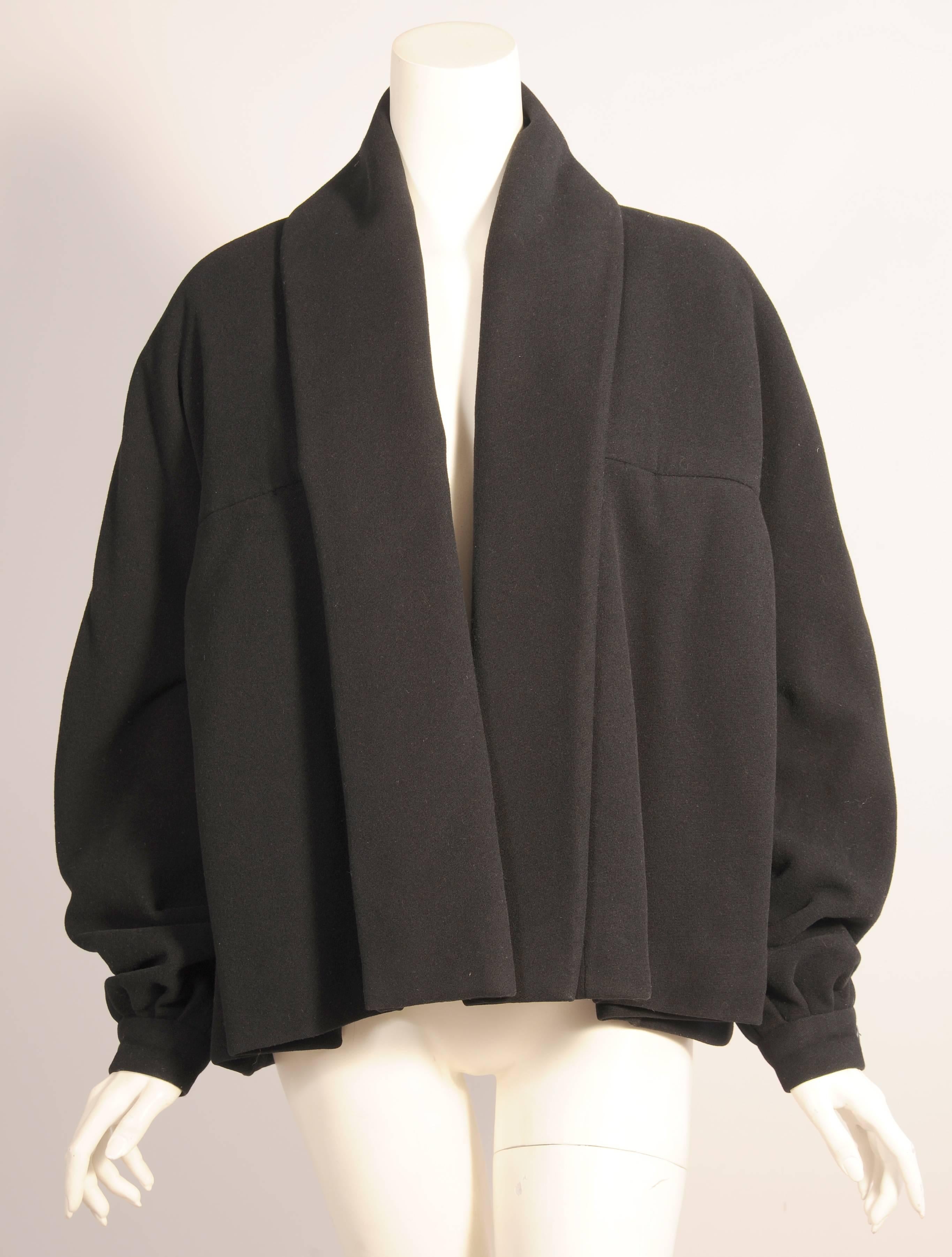 This fabulous Dior Couture jacket is so iconic of the post war 1950's look, and yet it is stylish and wearable today.  It has very clean lines and no closure at the front. The shawl collar wraps around all the way to the hemline.  The pockets are