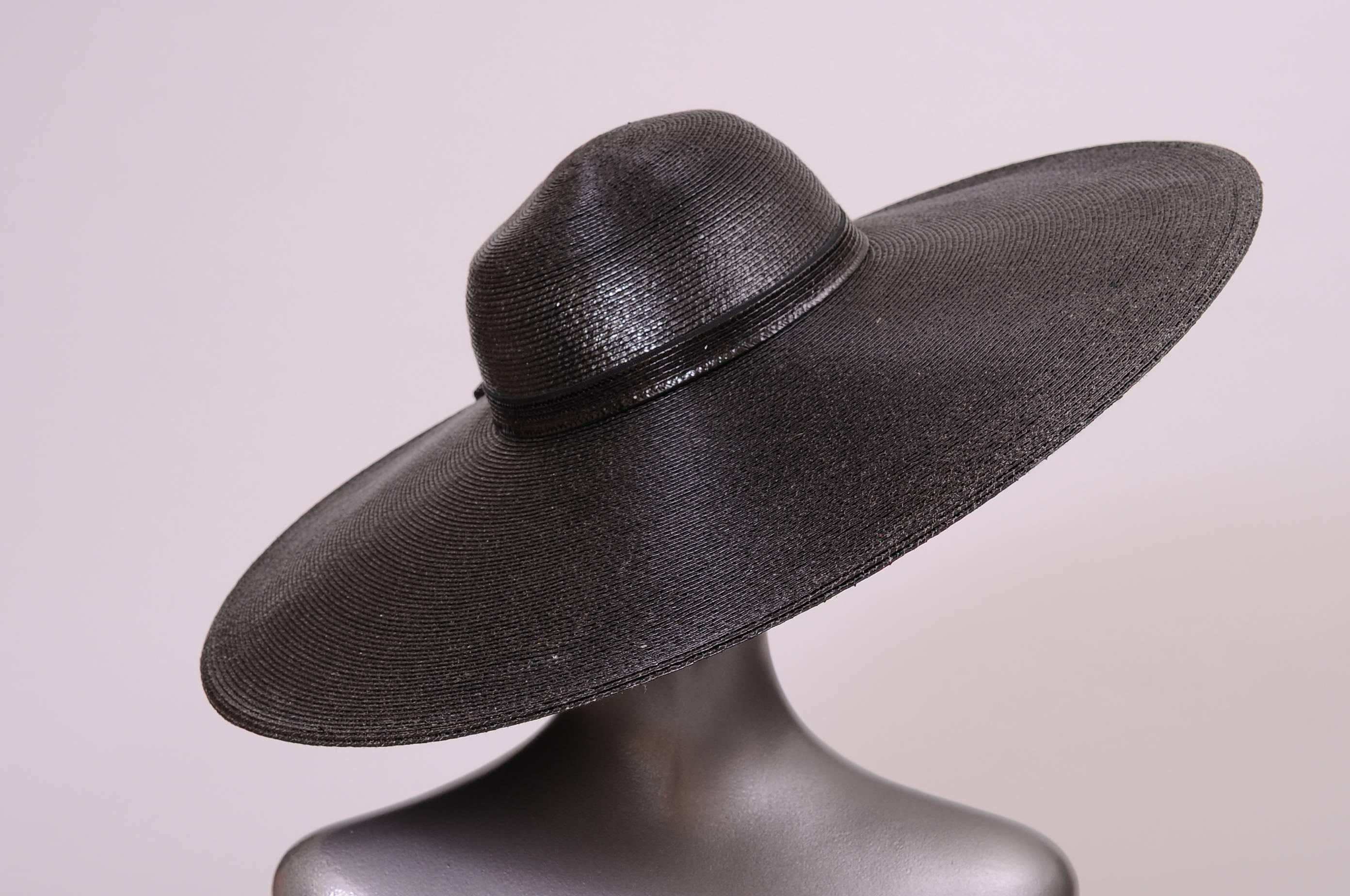 This fabulous big picture hat made from a shiny black straw was designed by Bellini for the high end retailer Nan Duskin. The hat has a decorative straw ribbon at the crown and it is in excellent condition.
Measurements;
Interior circumference