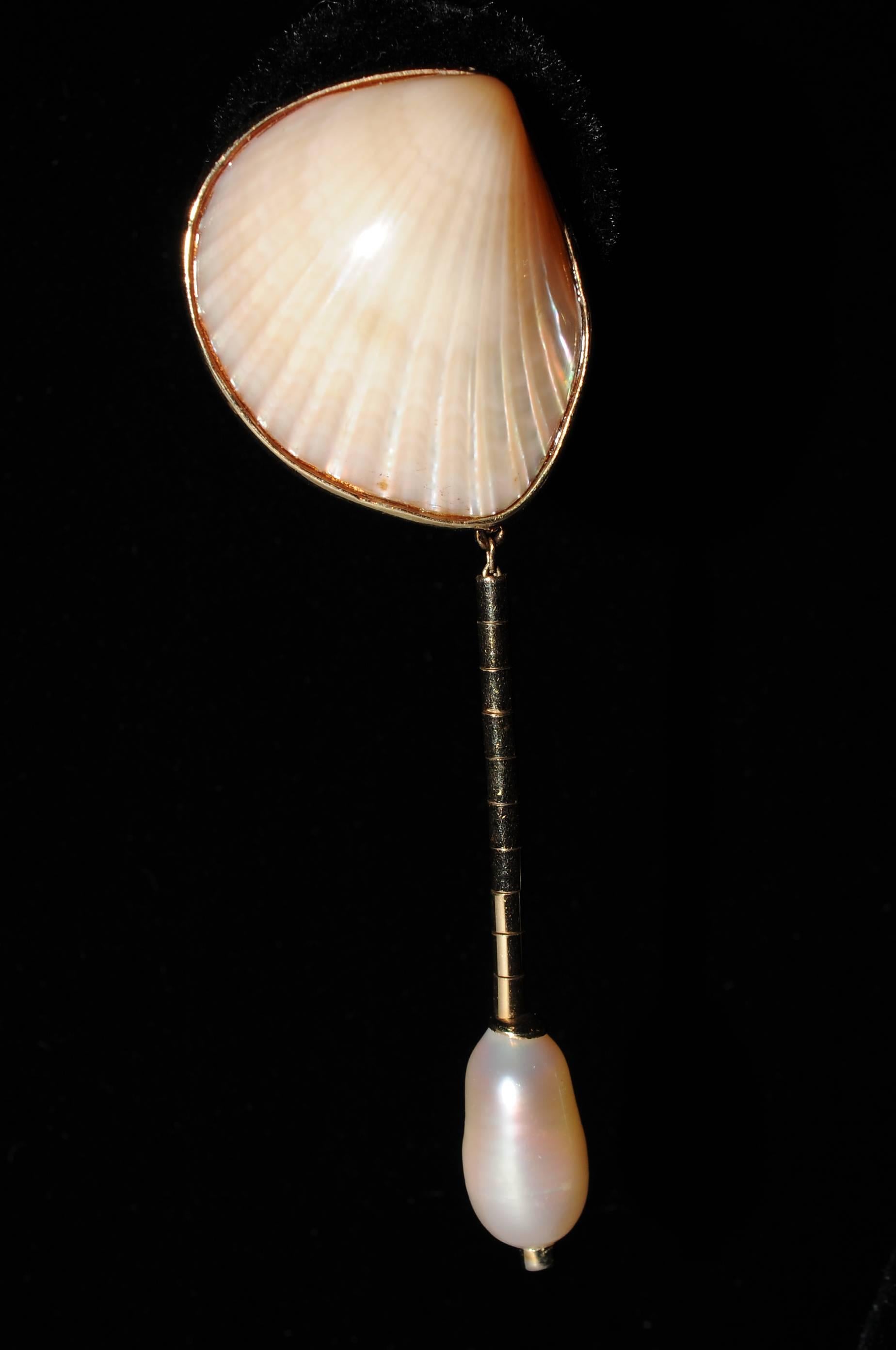These earrings are so versatile, you can wear the gold trimmed shells by day and add the pearl diamond and gold drop for evening. The shells have a clip back and there is a hook for the drop. The drop has 14k gold bugle beads, a large baroque pearl