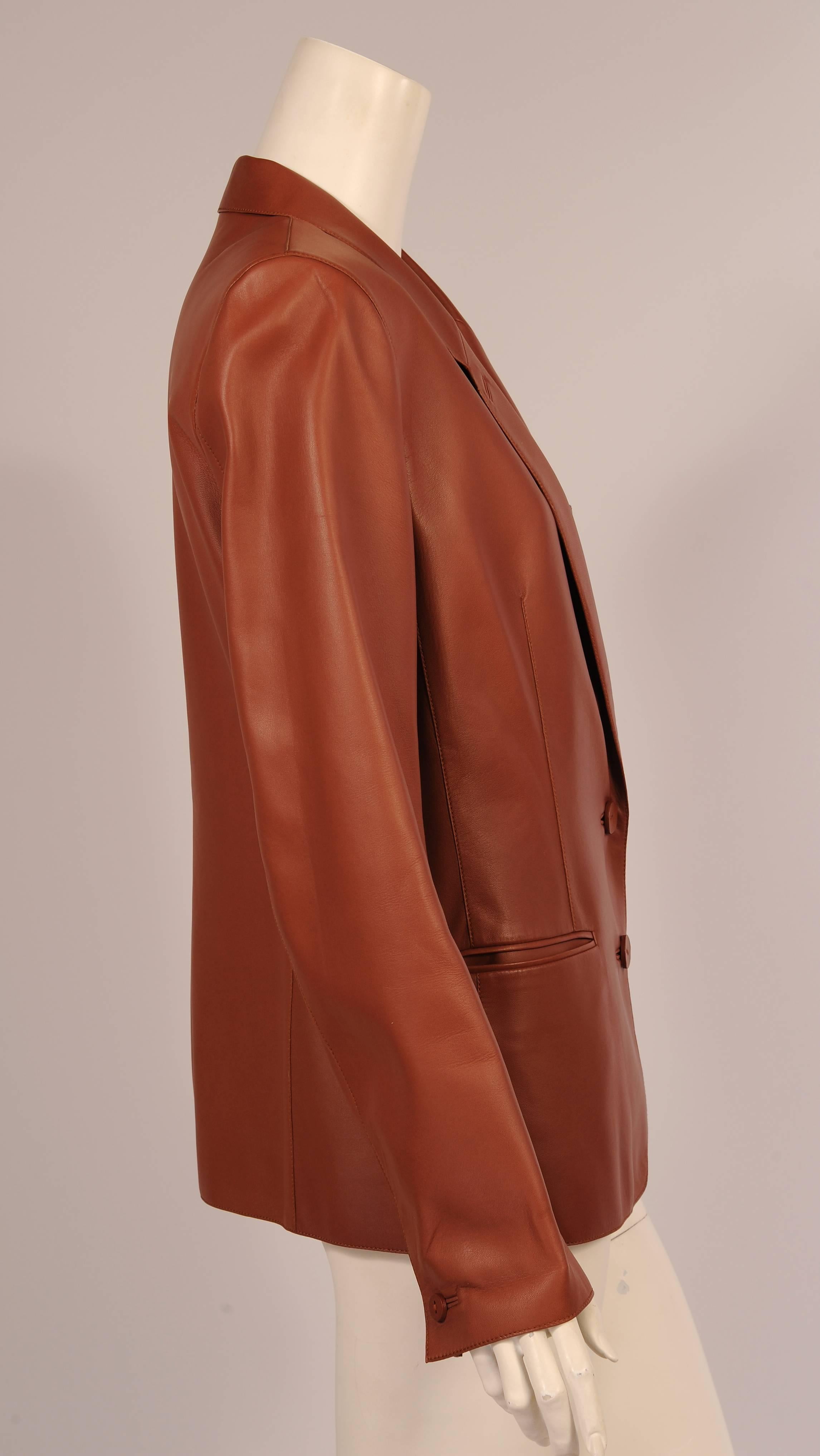 Martin Margiela used the softest caramel colored lambskin for this stylish two button blazer for Hermes. The buttons are leather backed by horn buttons on the inside of the center front and the cuffs. The jacket has a narrow notched lapel, one