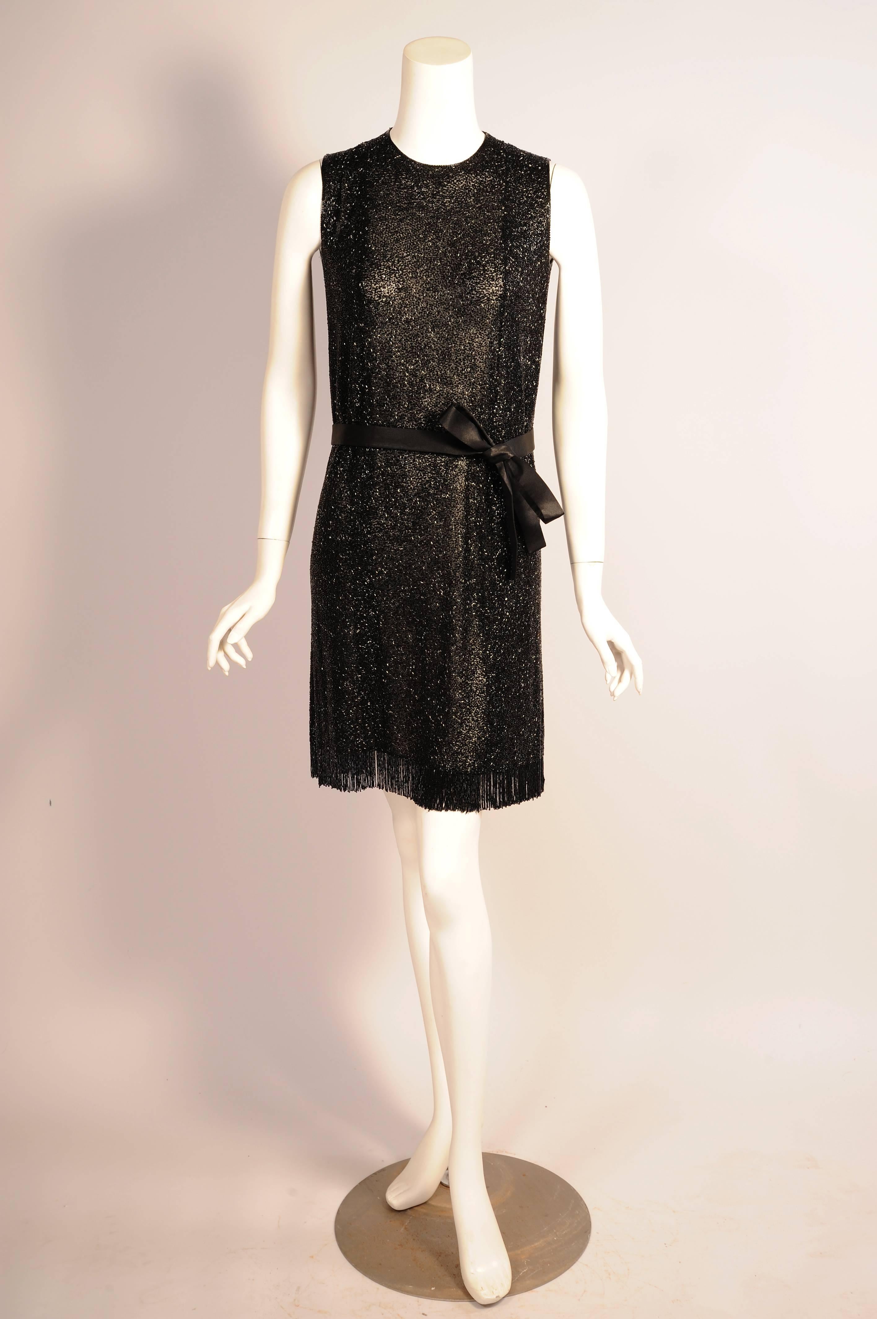 The designs of Norman Norell are timeless, this dress looks as current today 
as it did when it  was designed in the 1960's. The classic sleeveless silk chiffon sheath is completely covered in hand beaded black bugle beads. The hemline has a thick
