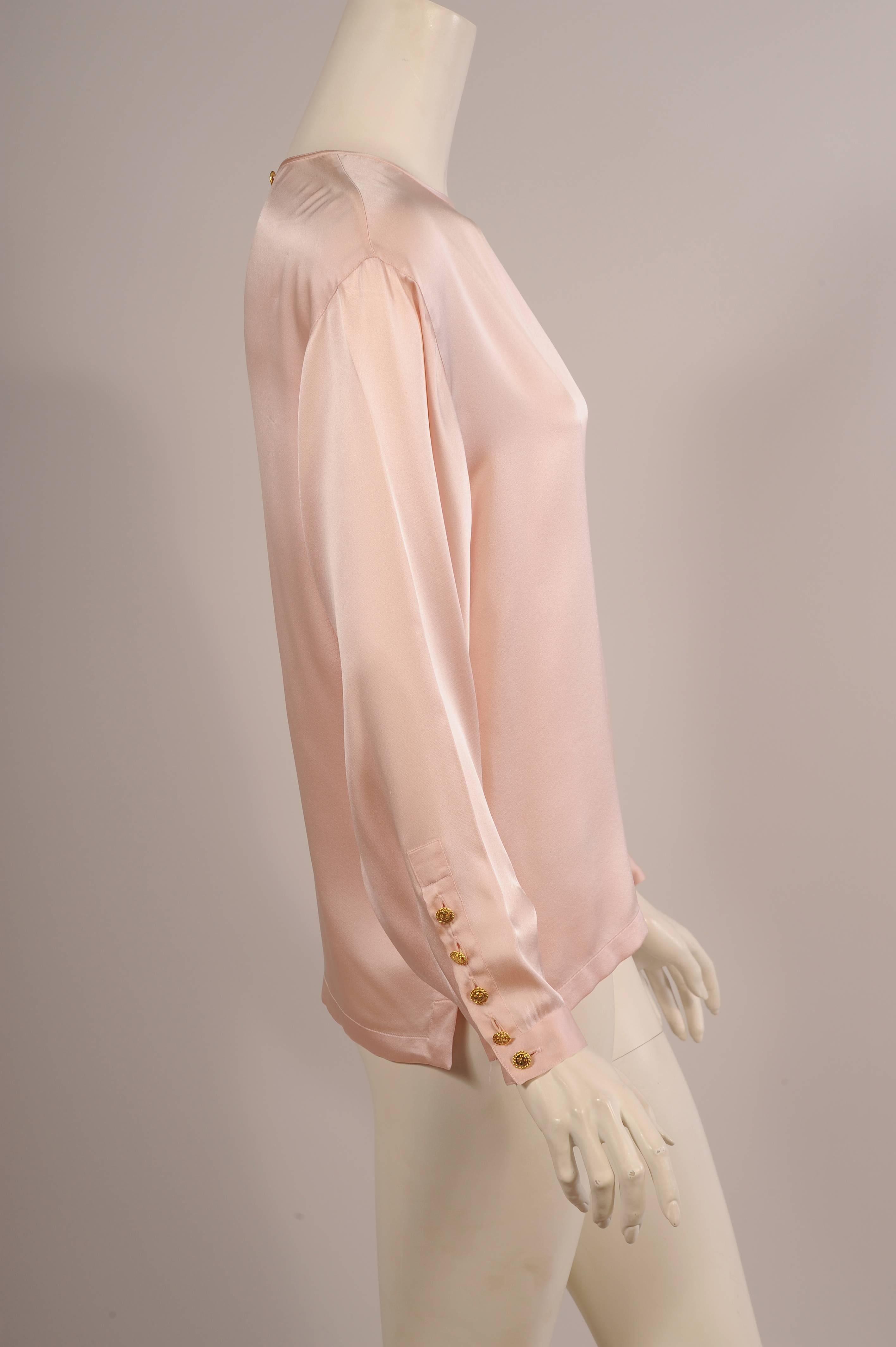 This gorgeous pale pink silk charmeuse blouse just slides on over your head. There is a shamrock button and silk loop at the center back. The long sleeves have five matching buttons with shamrocks. The hemline is split on each side so that the