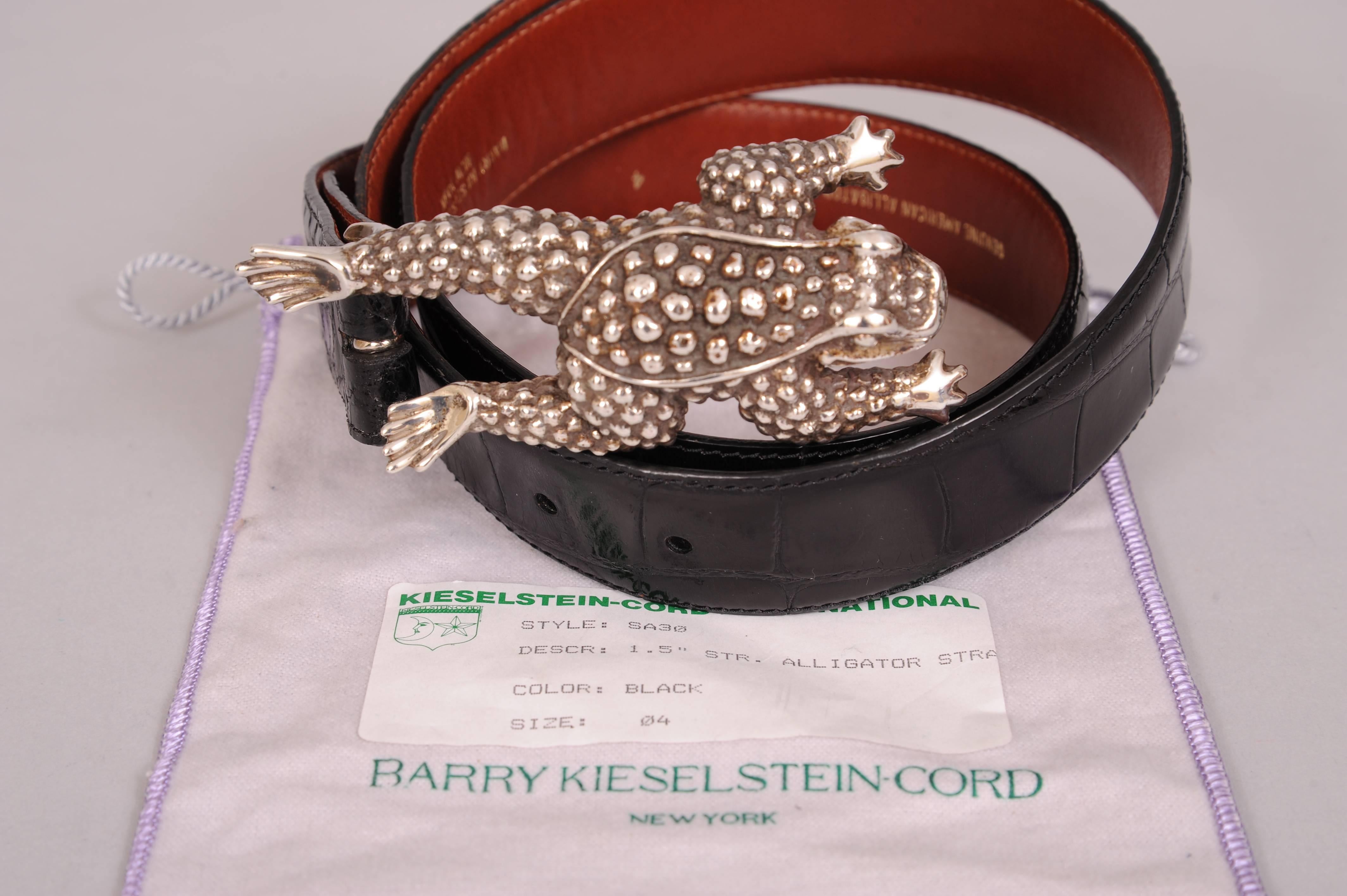 A whimsical sterling silver frog buckle is combined with a black alligator belt designed by Barry Kieselstein-Cord. The buckle is fully stamped and the belt is as well. In addition it is marked number 4. It fits a 32" to 36" waist. Both