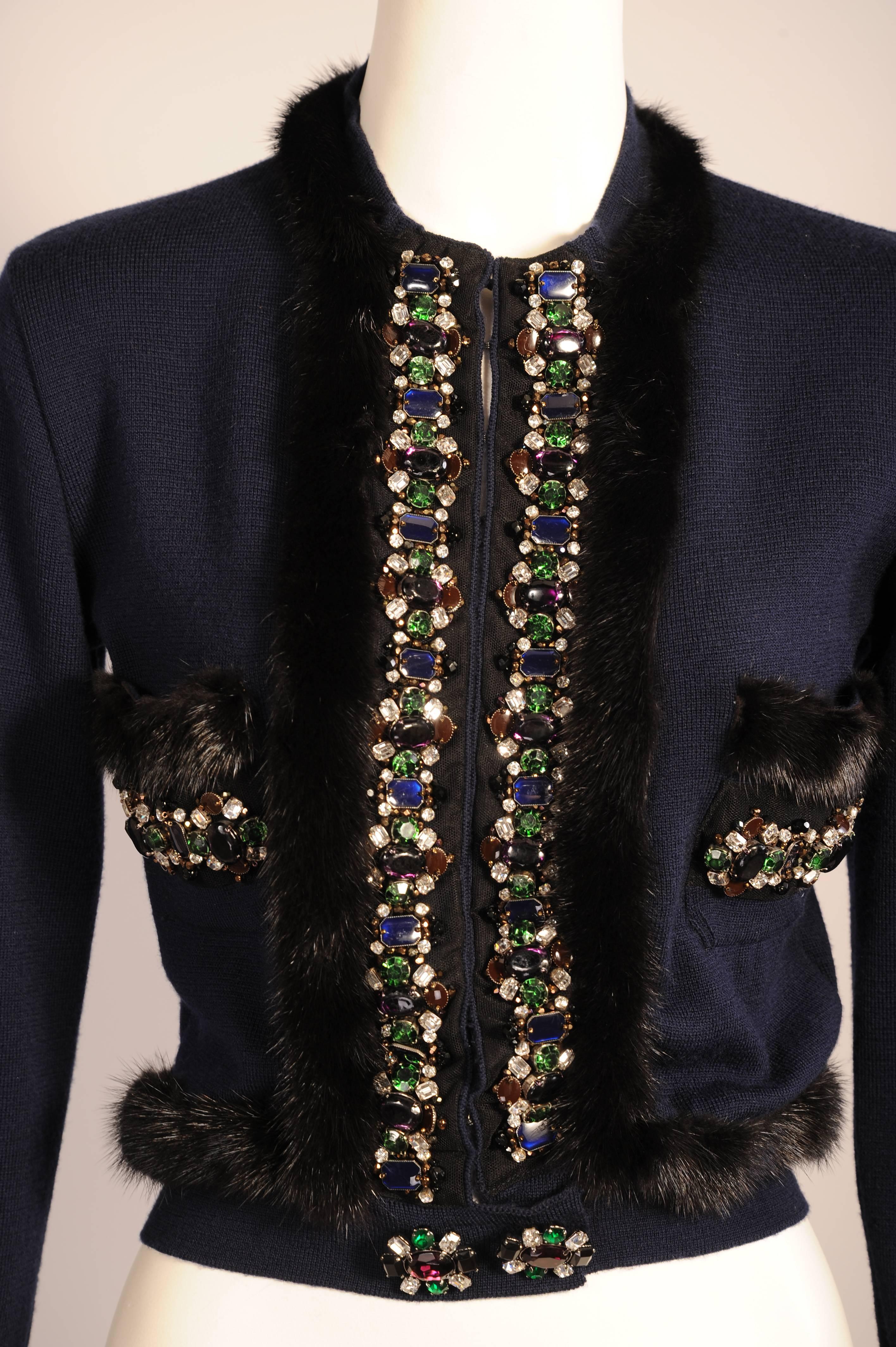 A navy blue cardigan has never looked so glamorous! Gianfranco Ferre has designed a sweater  made from Extra Fine merino Wool with a concealed hook and eye closure at the center front. This is edged with a mesh band covered in jewels in shades of