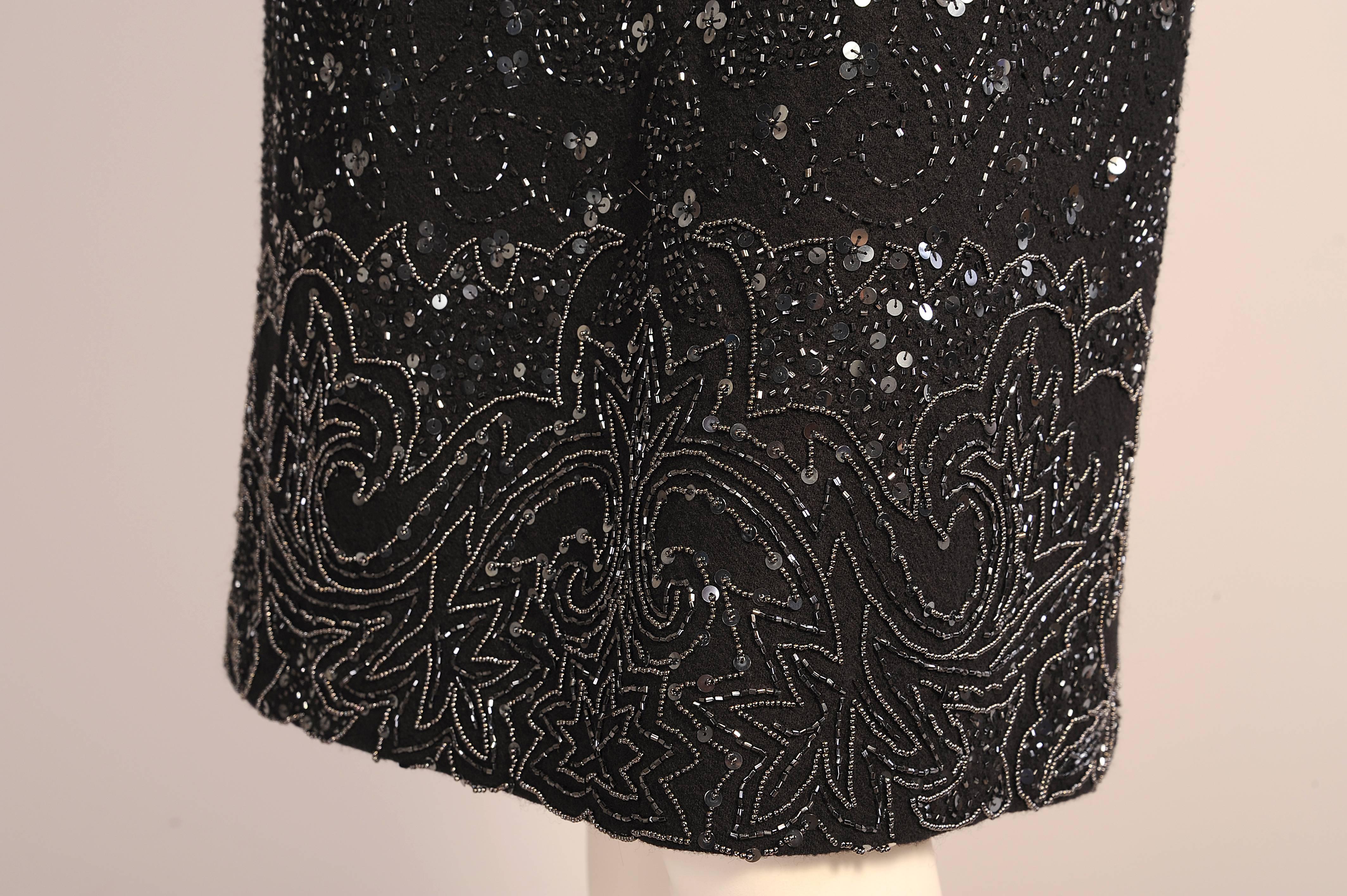 This slim skirt is completely beaded with black bugle beads in an abstract vine design. This is accentuated with clusters of black sequins. The border design incorporates caviar beads outlining the the stylized leaf and vine pattern. The skirt is