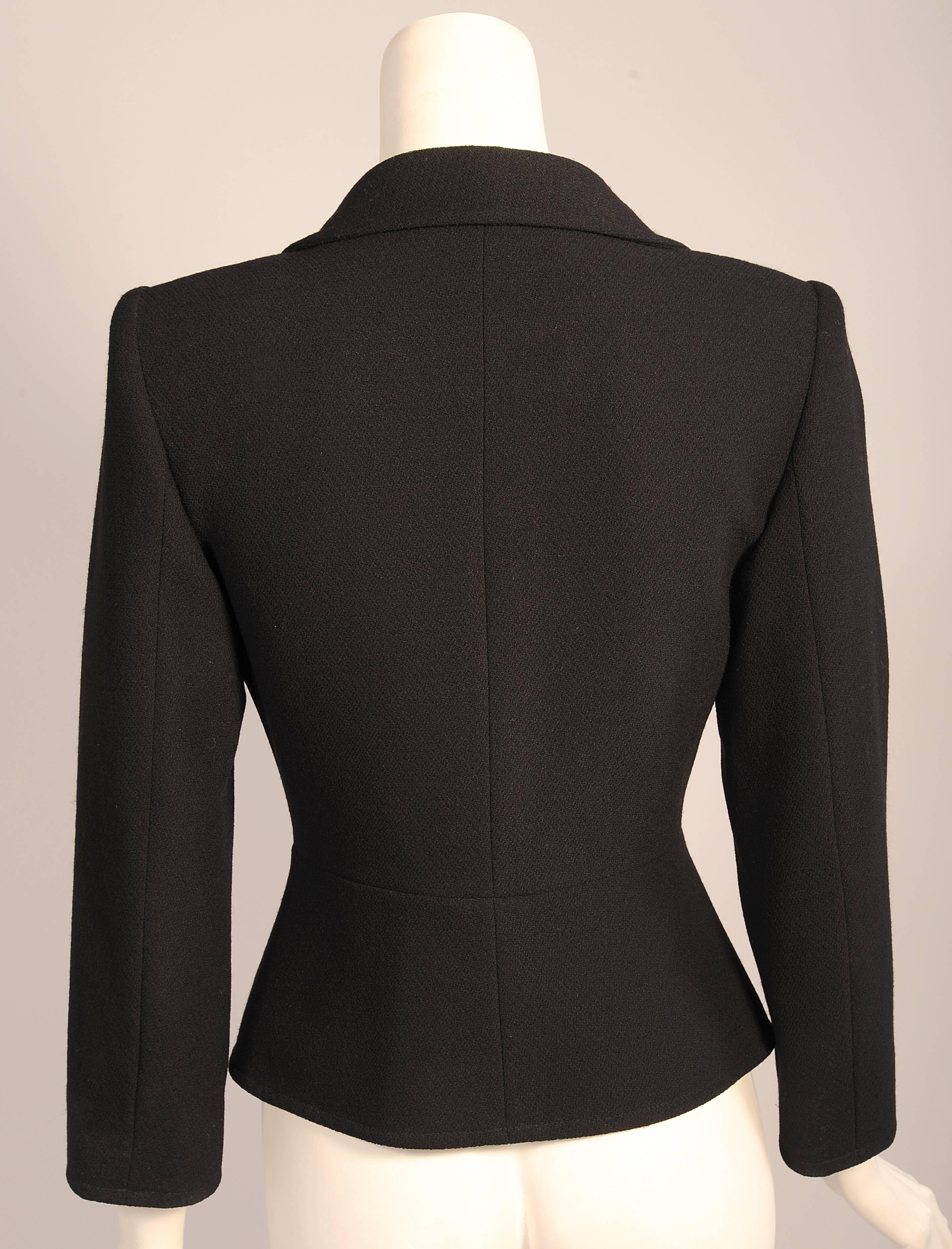 This Christian Lacroix black wool  crepe blazer has a notched lapel, single button closure and two smaller buttons on the jacket pockets. It is fully lined and is marked a size 36. It is in excellent condition.
Measurements;
Shoulders 16