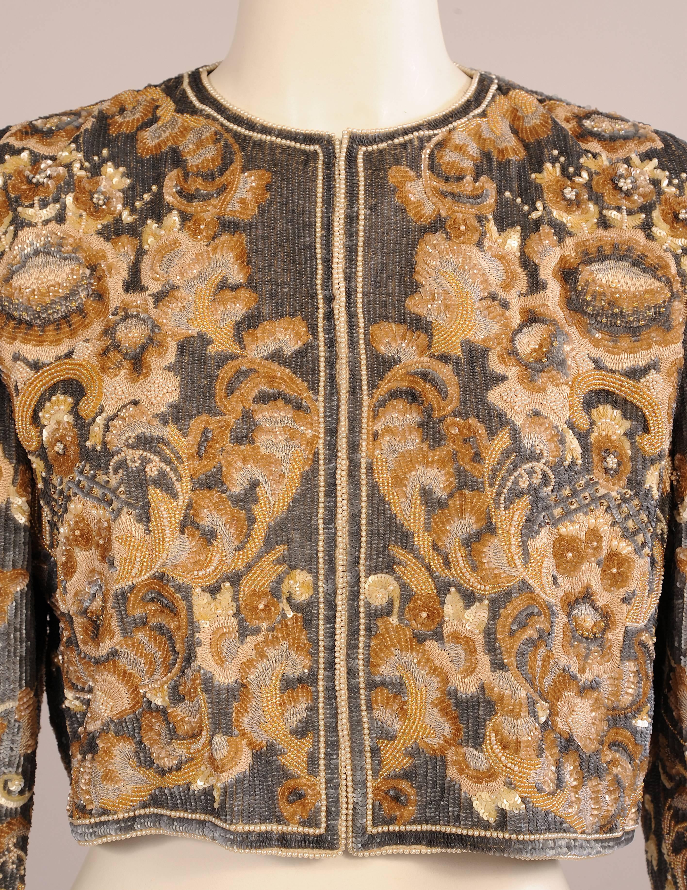 Completely covered in beads, sequins, pearls and embroidery this stunning evening jacket has a floral design worked in shades of cream, beige, camel and charcoal grey.  Great with an evening dress it would also be fabulous with grey flannel or camel