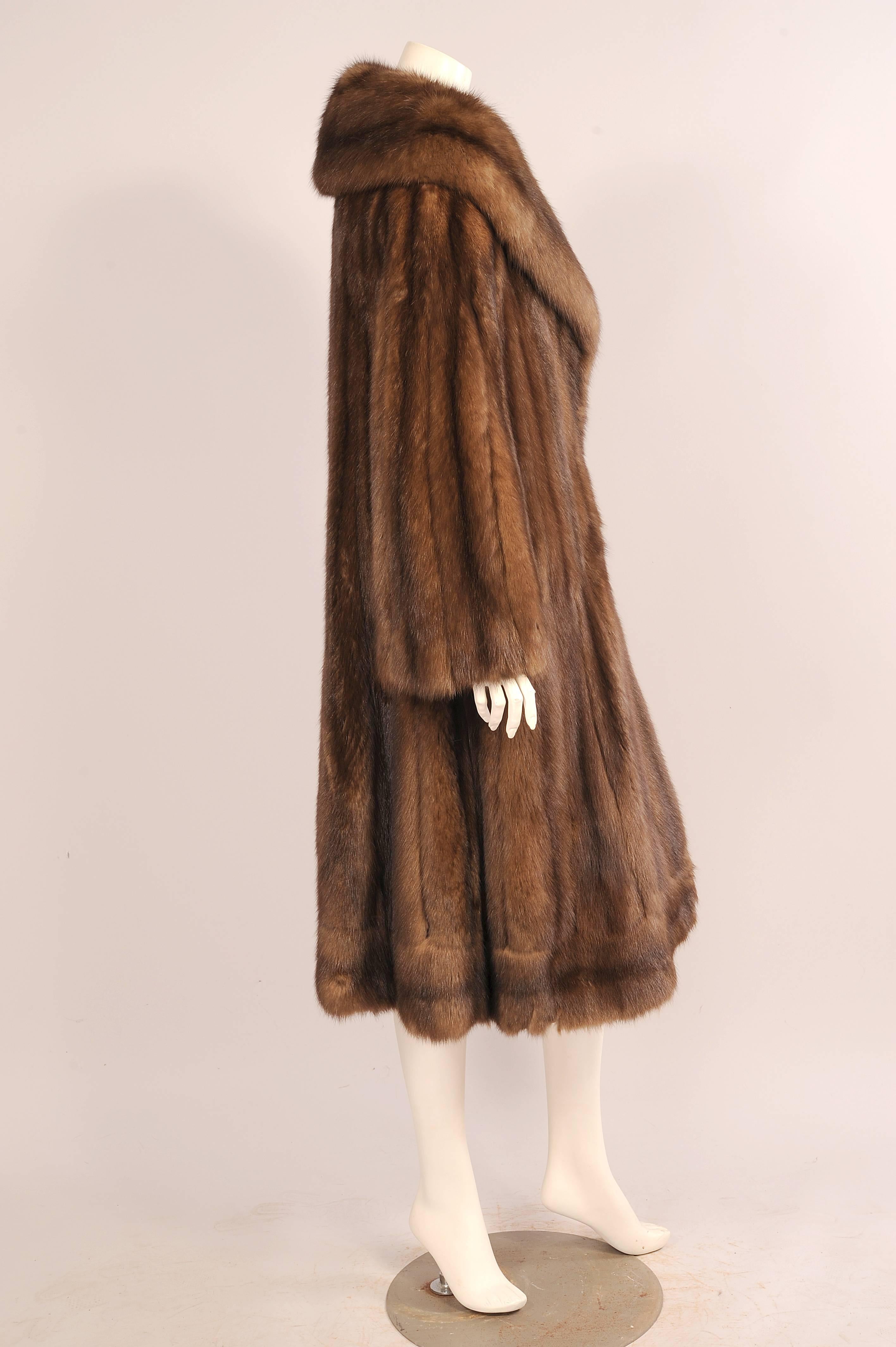 This full cut sable swing style coat with shawl collar does not skimp on sable pelts. Retailed by Dallas, Texas
furrier John Tauben this luxurious coat has a generous full cut with lots of movement. The face framing collar is balanced by the