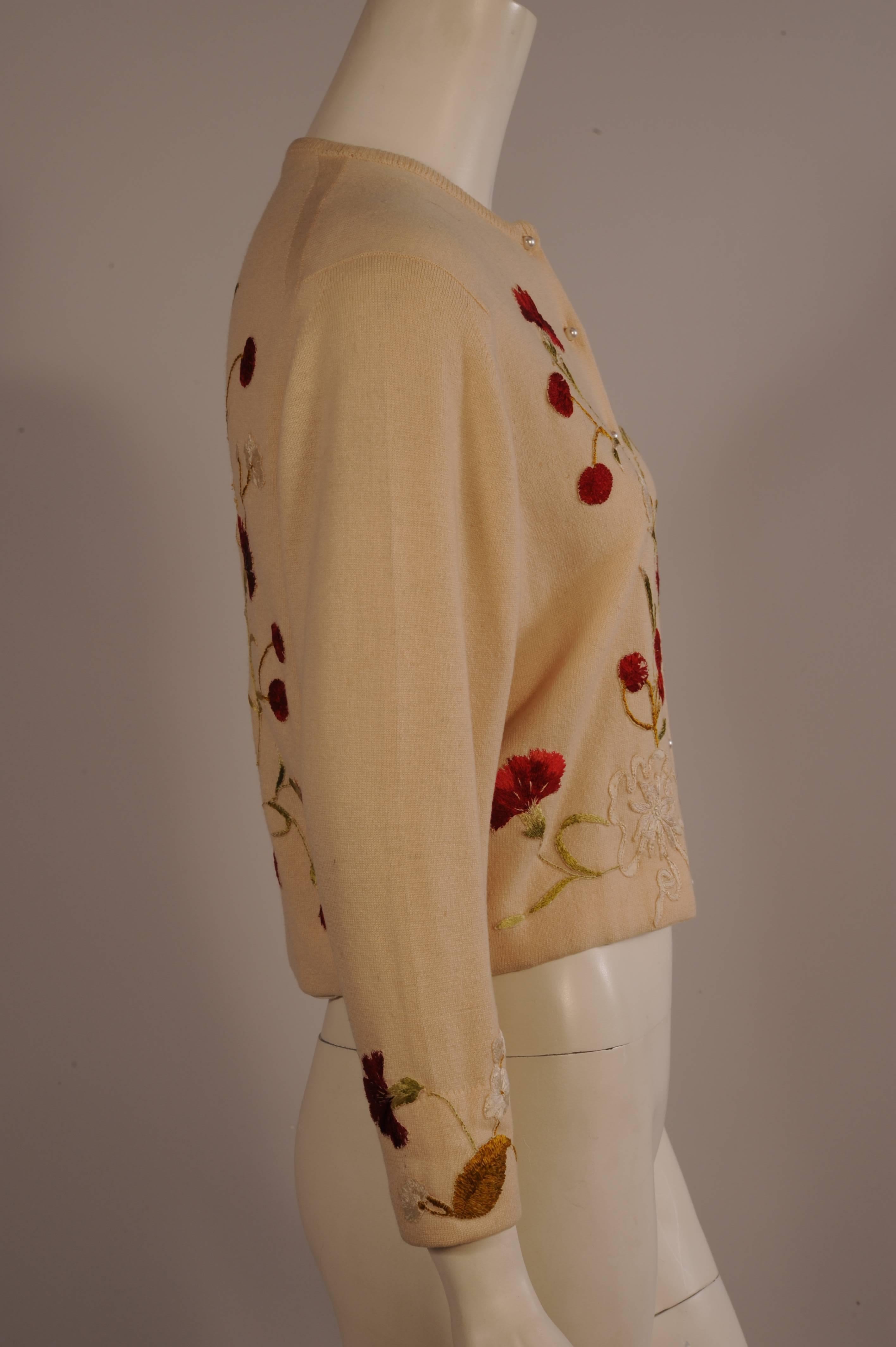 A luxurious cream cashmere sweater, purchased from Bergdorf Goodman, was altered and enhanced by the seamstress' working in the ballroom of the home of Helen Bond Carruthers. The front, back and cuffs have been hand appliqued with silk hand
